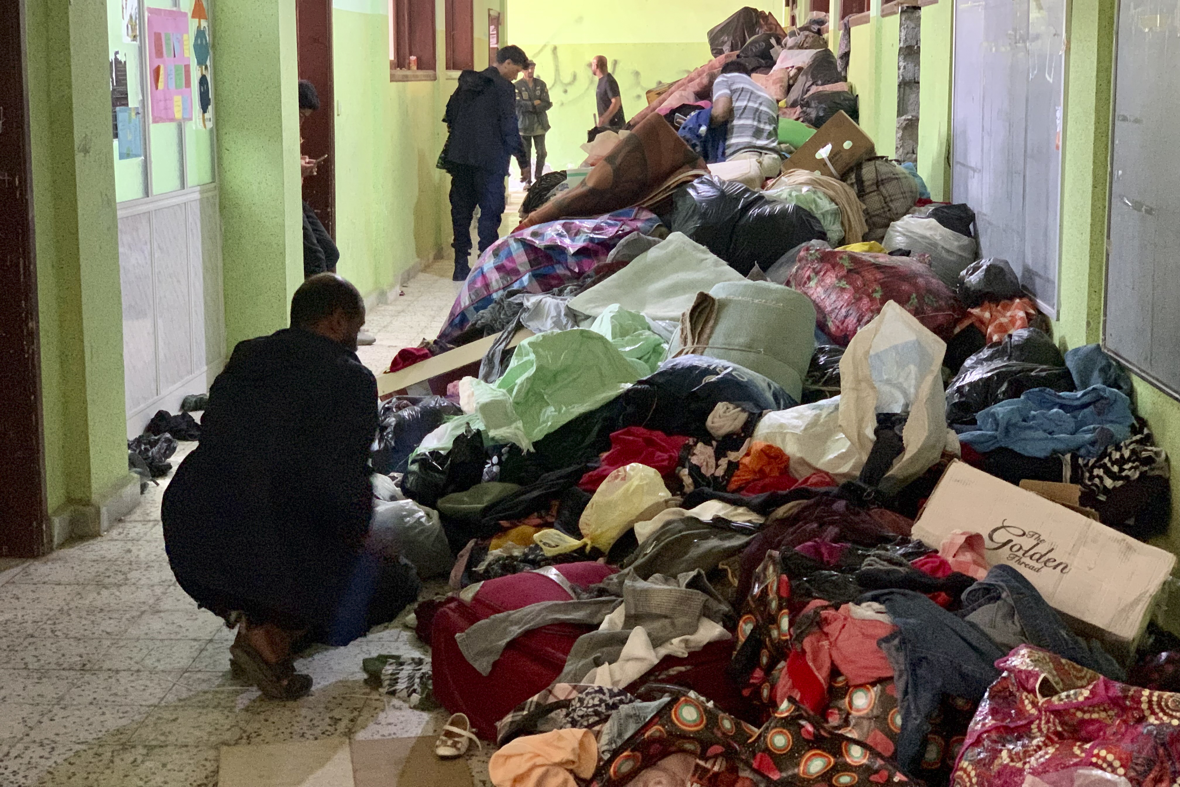 People deliver donated clothes to a flash flood-destroyed city of Derna