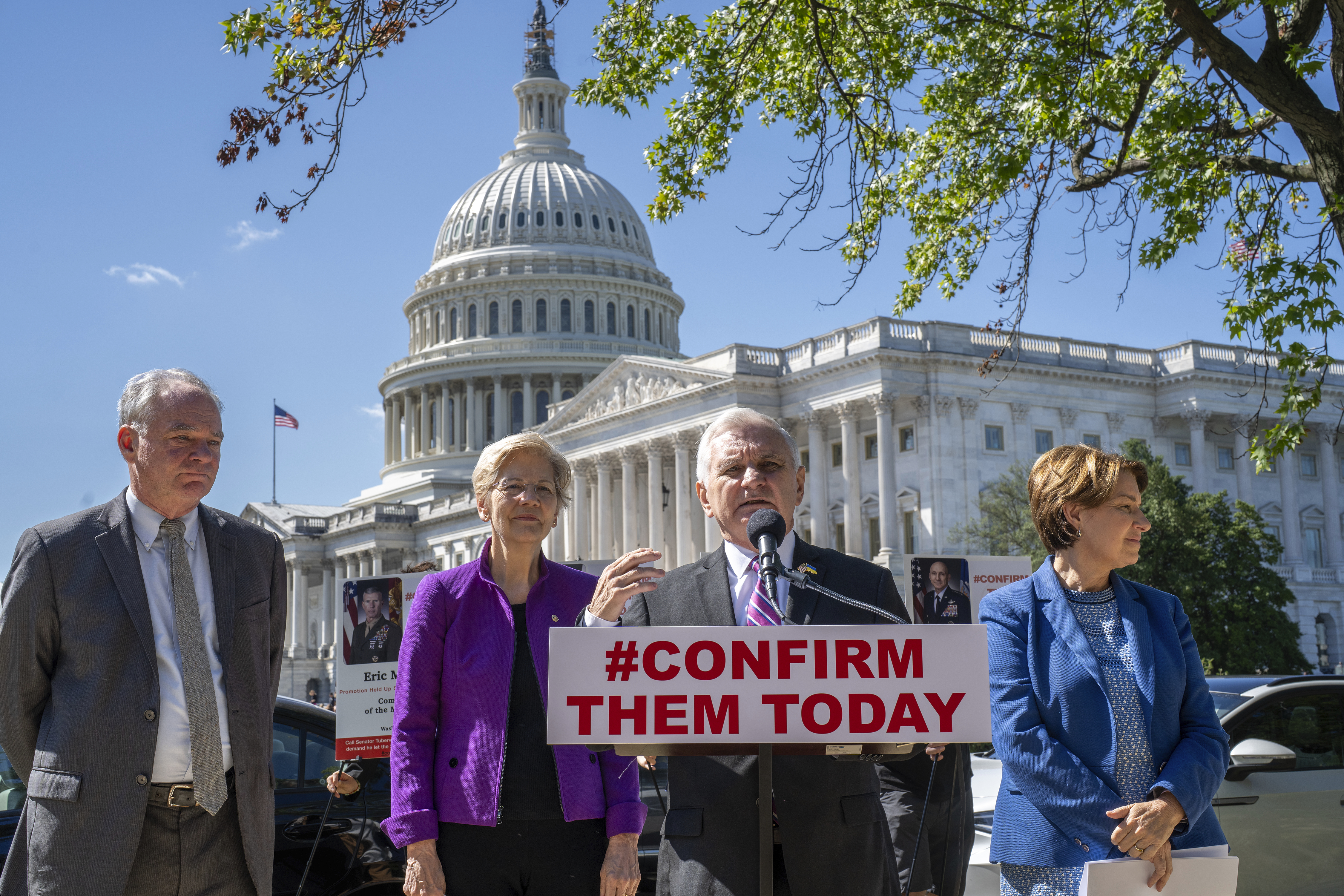 Armed Services Committee Chair Jack Reed, D-R.I., center, joined from left by Sen. Tim Kaine, D-Va., Sen. Elizabeth Warren, D-Mass., and Sen. Amy Klobuchar, D-Minn., speaks to reporters about the standoff over military promotions led by Sen. Tommy Tuberville, R-Ala., at the Capitol in Washington, Tuesday, Sept. 19, 2023. Standing outside, with the Capitol dome behind them, they speak behind a sign that reads, "Confirm them today."