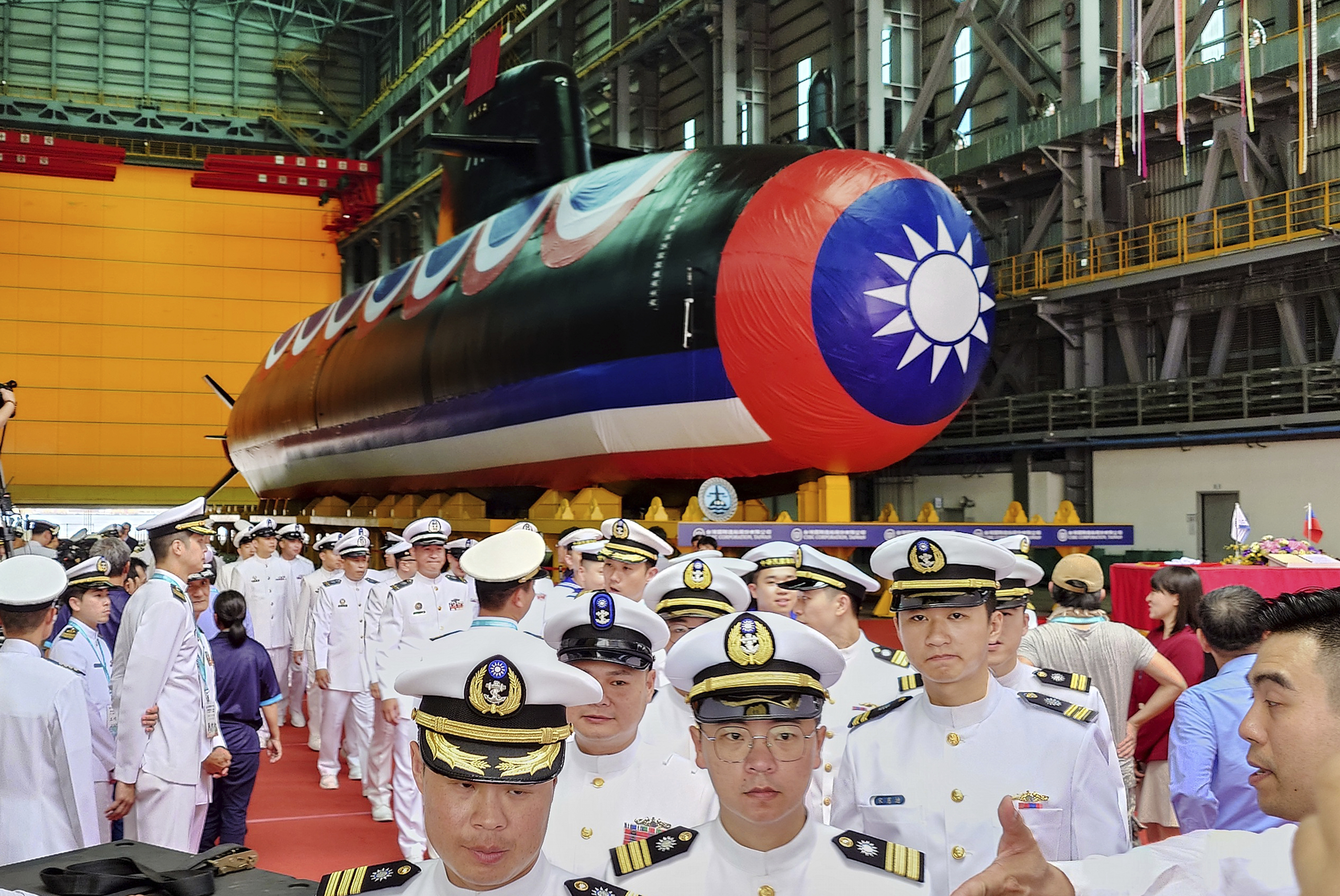 The new Taiwan submarine. Sailors in white uniforms are walking around it