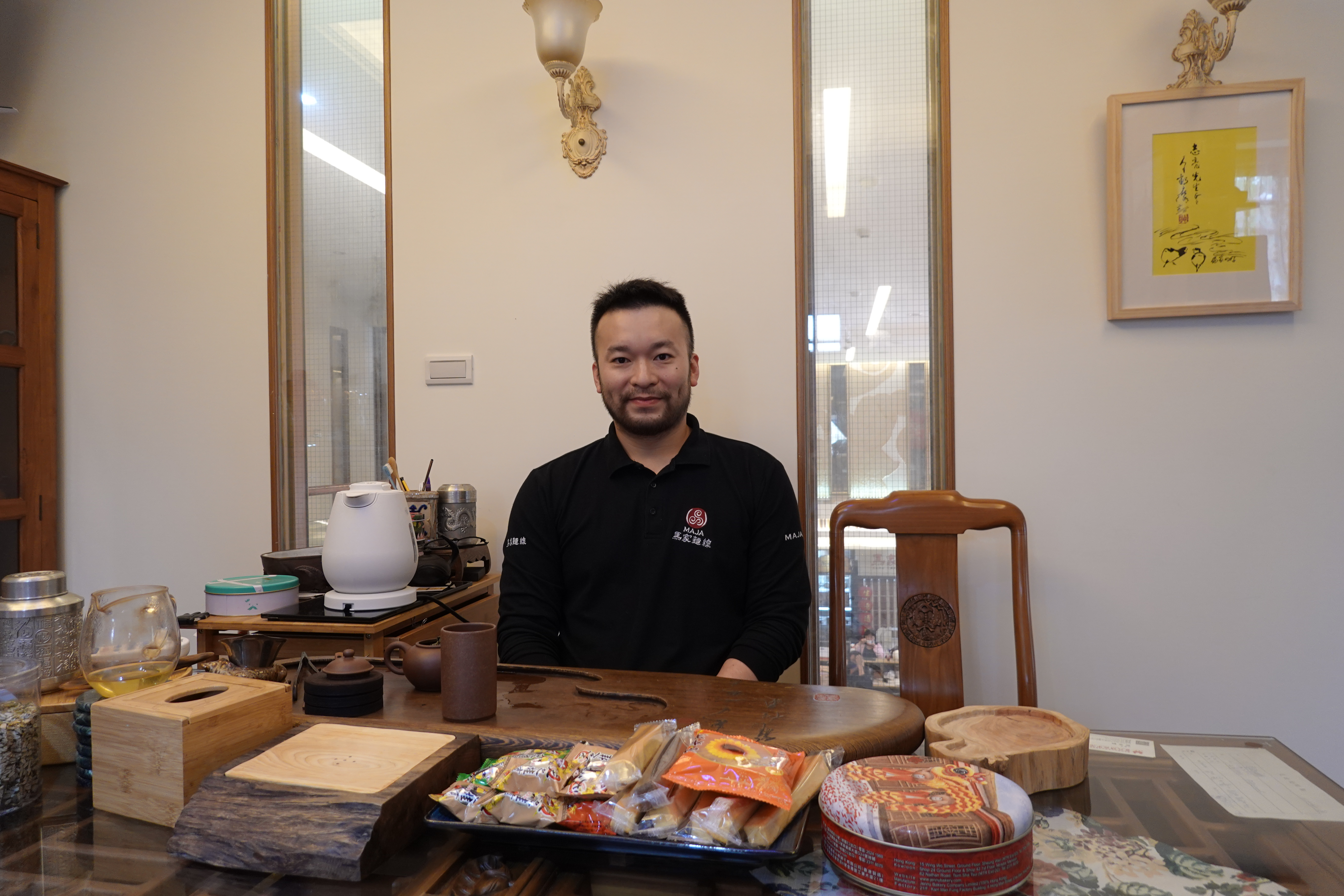 A photo of Ma Tsong Tin sitting in his office.