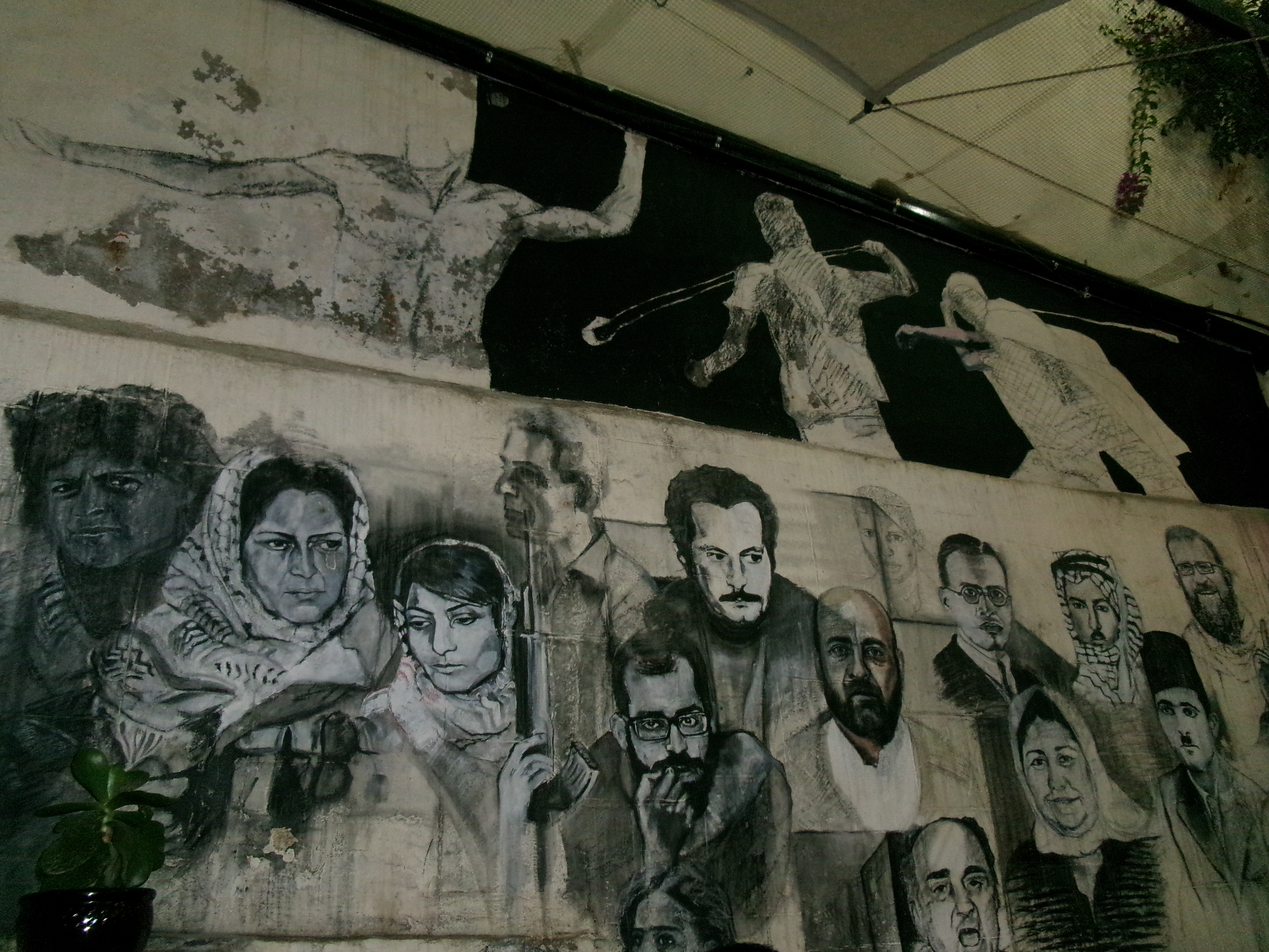 A wall at the Citadel restaurant in the West Bank, with sketches of iconic Palestinians, on October 10, 2023 [Laila Shadid/Al Jazeera]