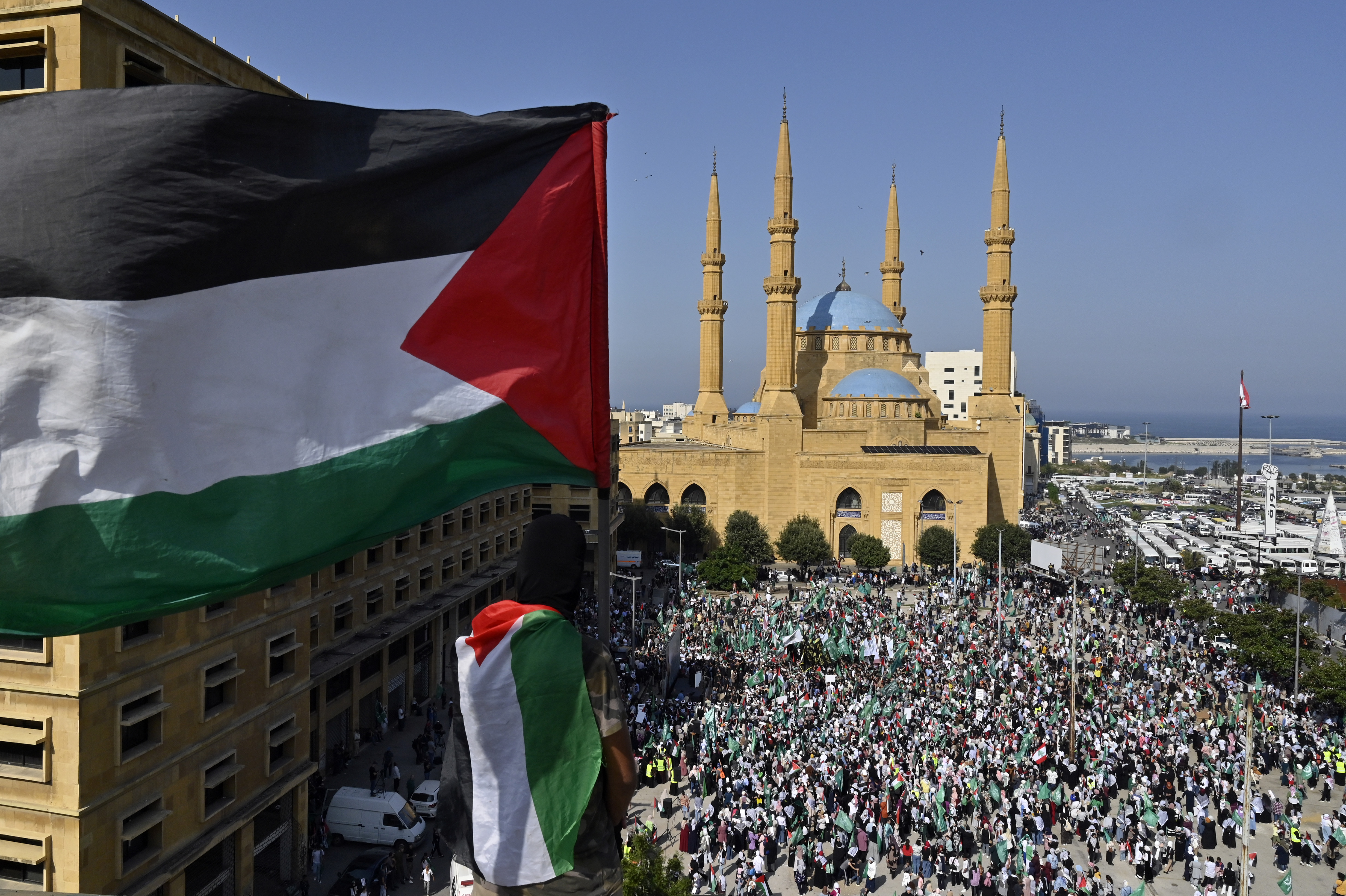 Supporters of the Islamic Group and Hamas movement carry Palestinian flags as they shout slogans during a protest in solidarity with the Palestinian people, amid the ongoing conflict between Israel and Hamas in the Gaza Strip, in downtown Beirut, Lebanon