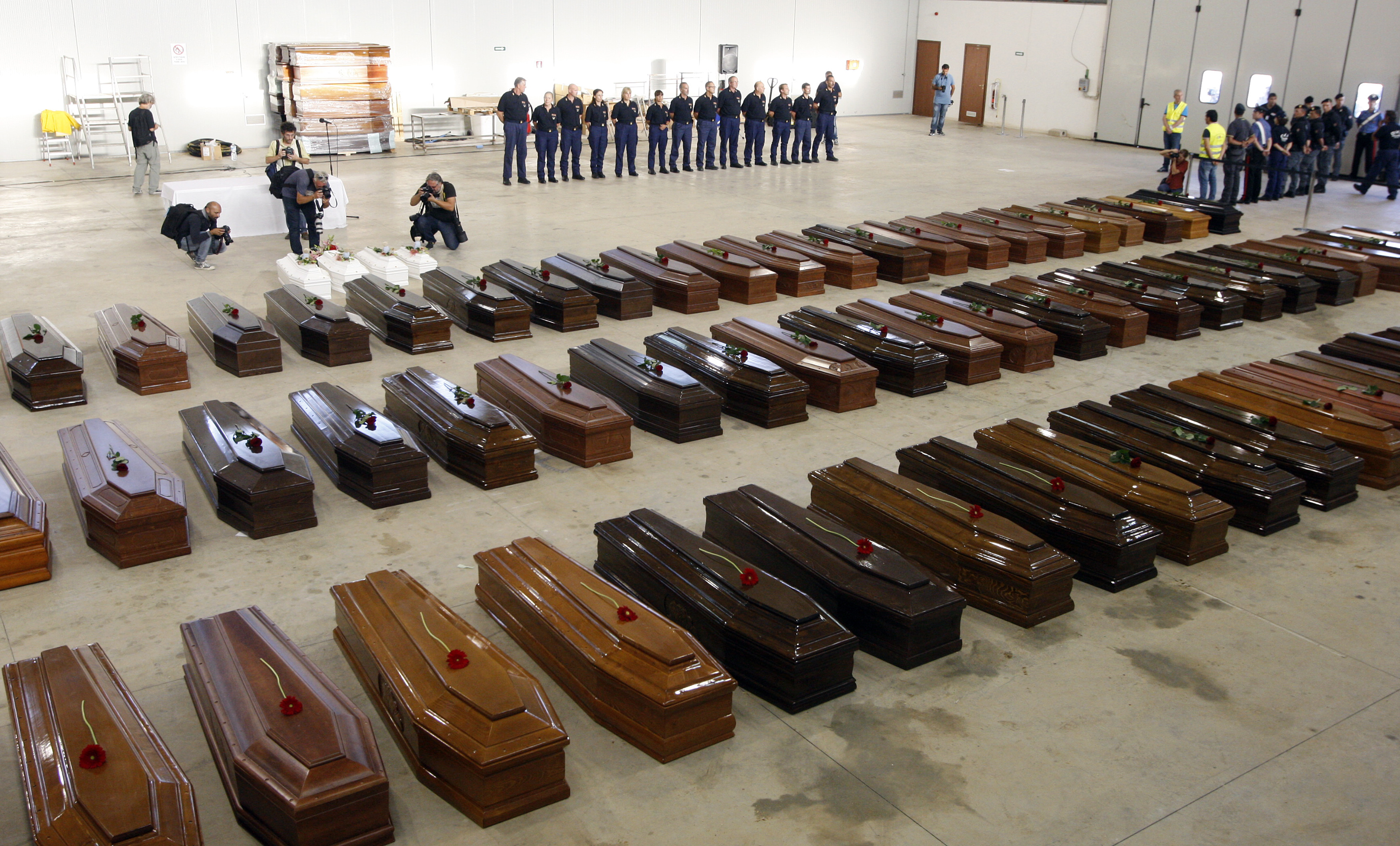 Coffins of victims from a shipwreck off Sicily are seen in a hangar of the Lampedusa airport October 5, 2013. Rough seas again blocked efforts to recover the bodies trapped inside a boat that sank on Thursday, killing an estimated 300 Eritrean and Somali men, women and children who were seeking a better life in Europe. REUTERS/Antonio Parrinello (ITALY - Tags: DISASTER)