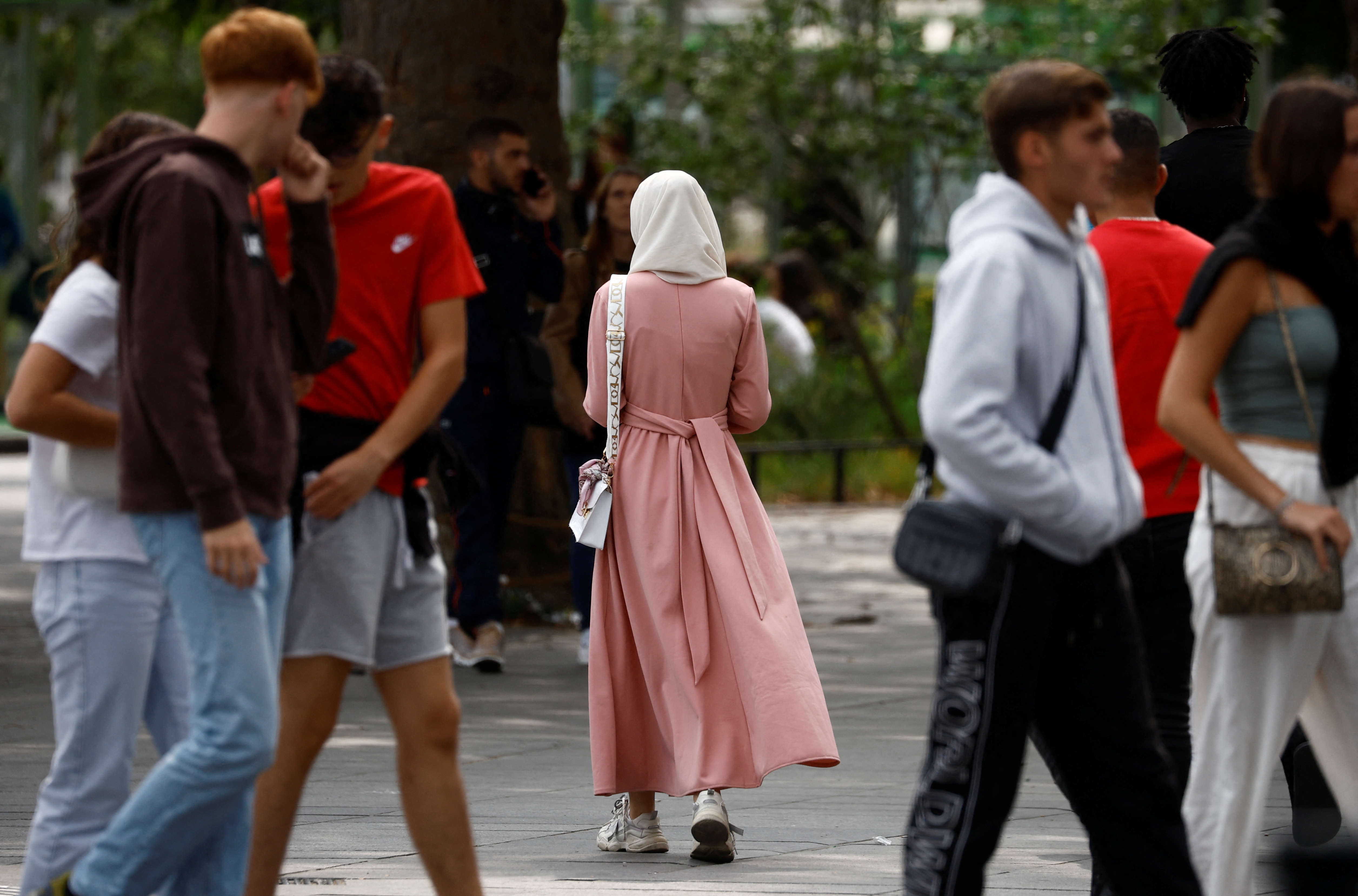 A Muslim woman, wearing the style of dress called an abaya, walks in a street in Nantes, France, August 29, 2023. REUTERS/Stephane Mahe
