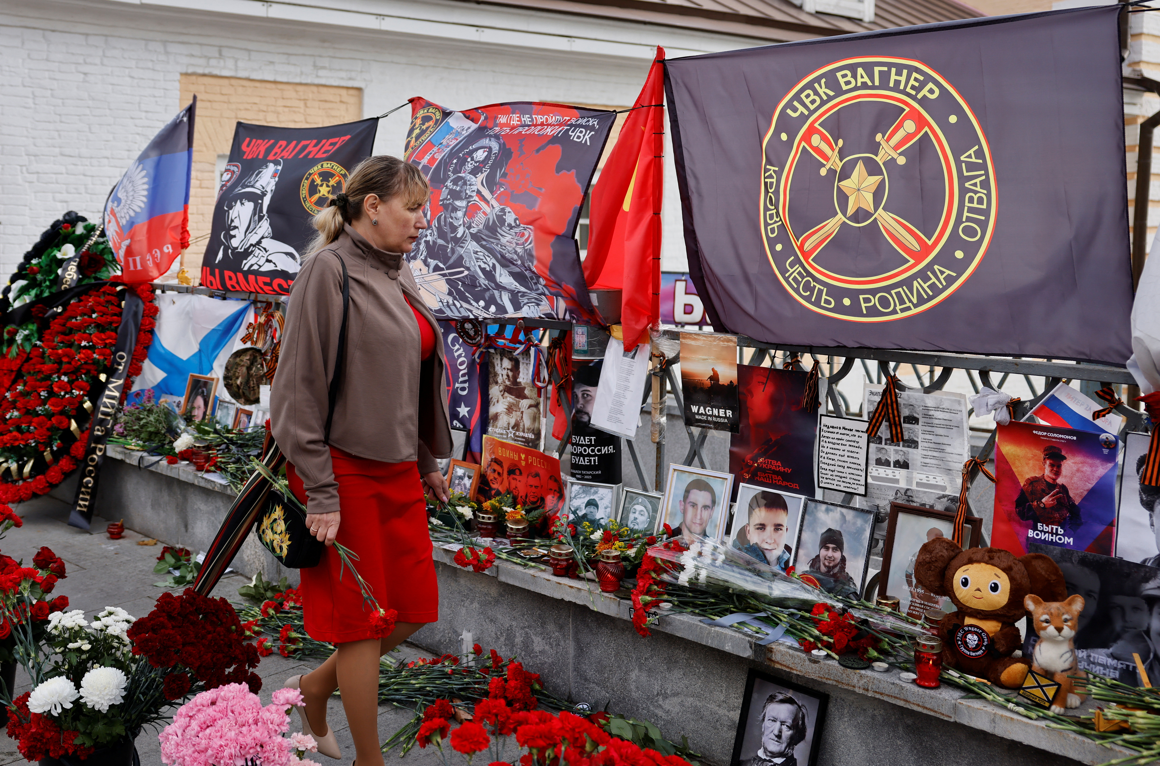 A woman paying respects at a makeshift memorial