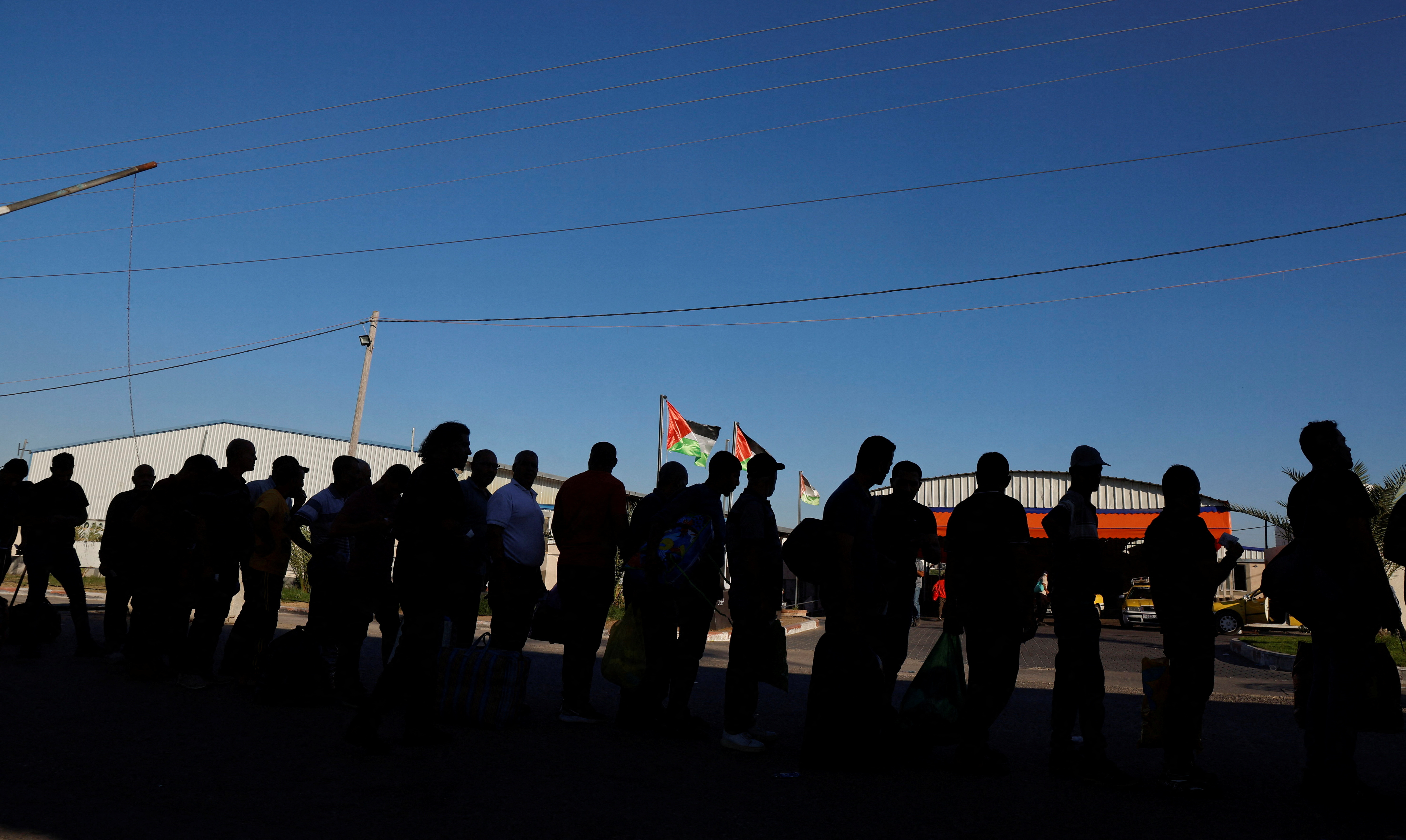 Palestinian workers wait to cross the Erez crossing to Israel in the northern Gaza Strip