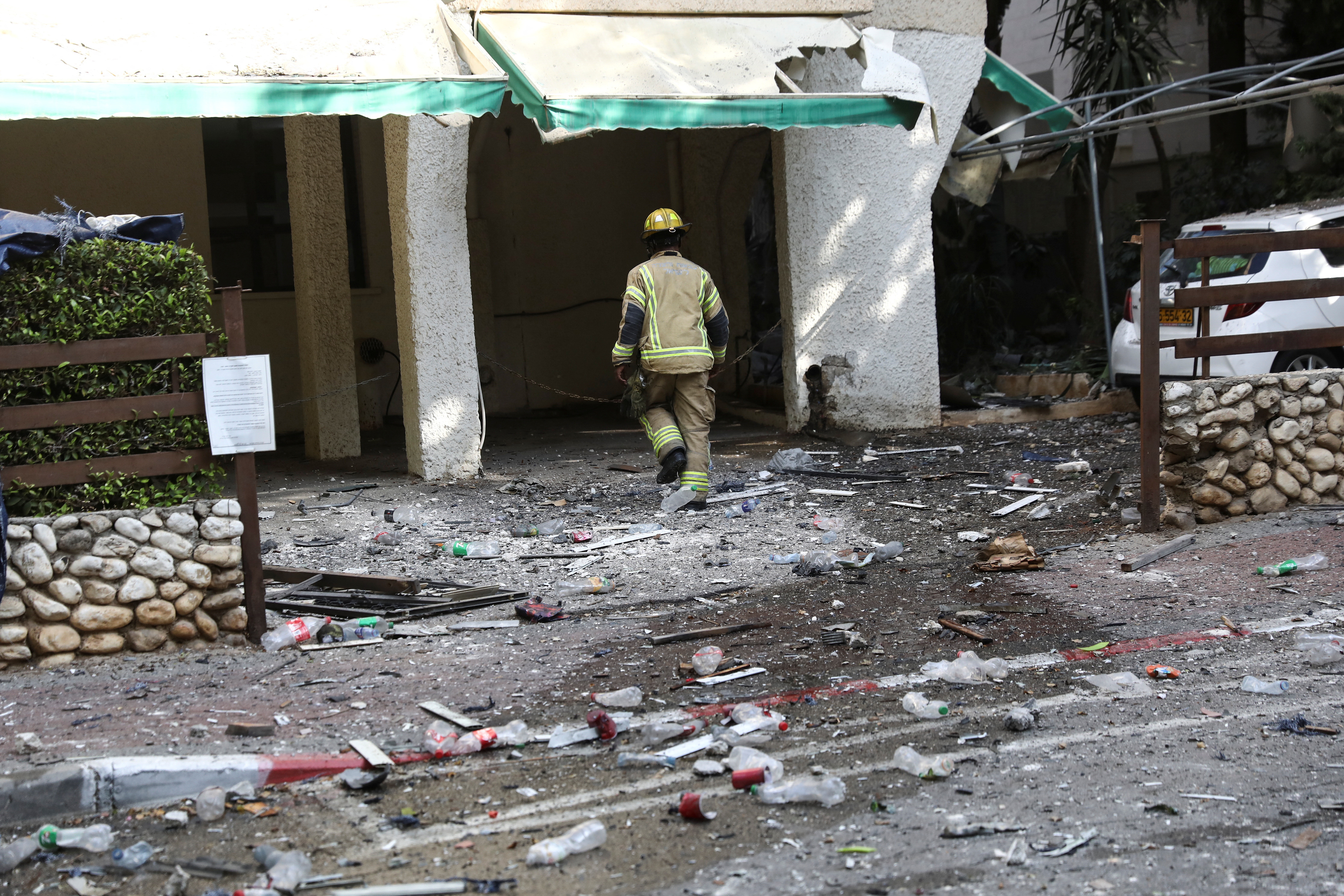 A firefighter walks towards a building