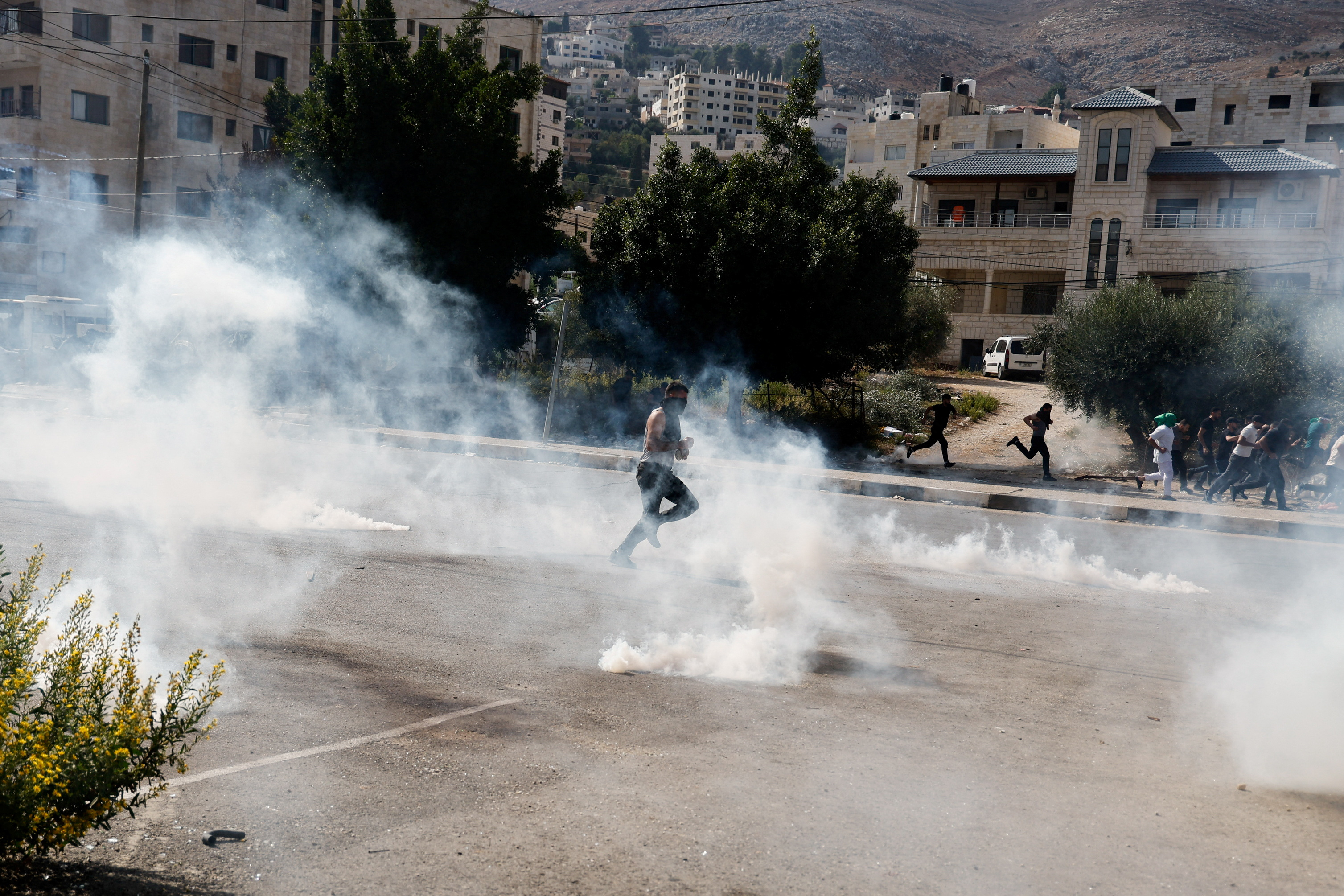 Smoke rises following a volley of tear gas against Palestinian protestors in the occupied West Bank