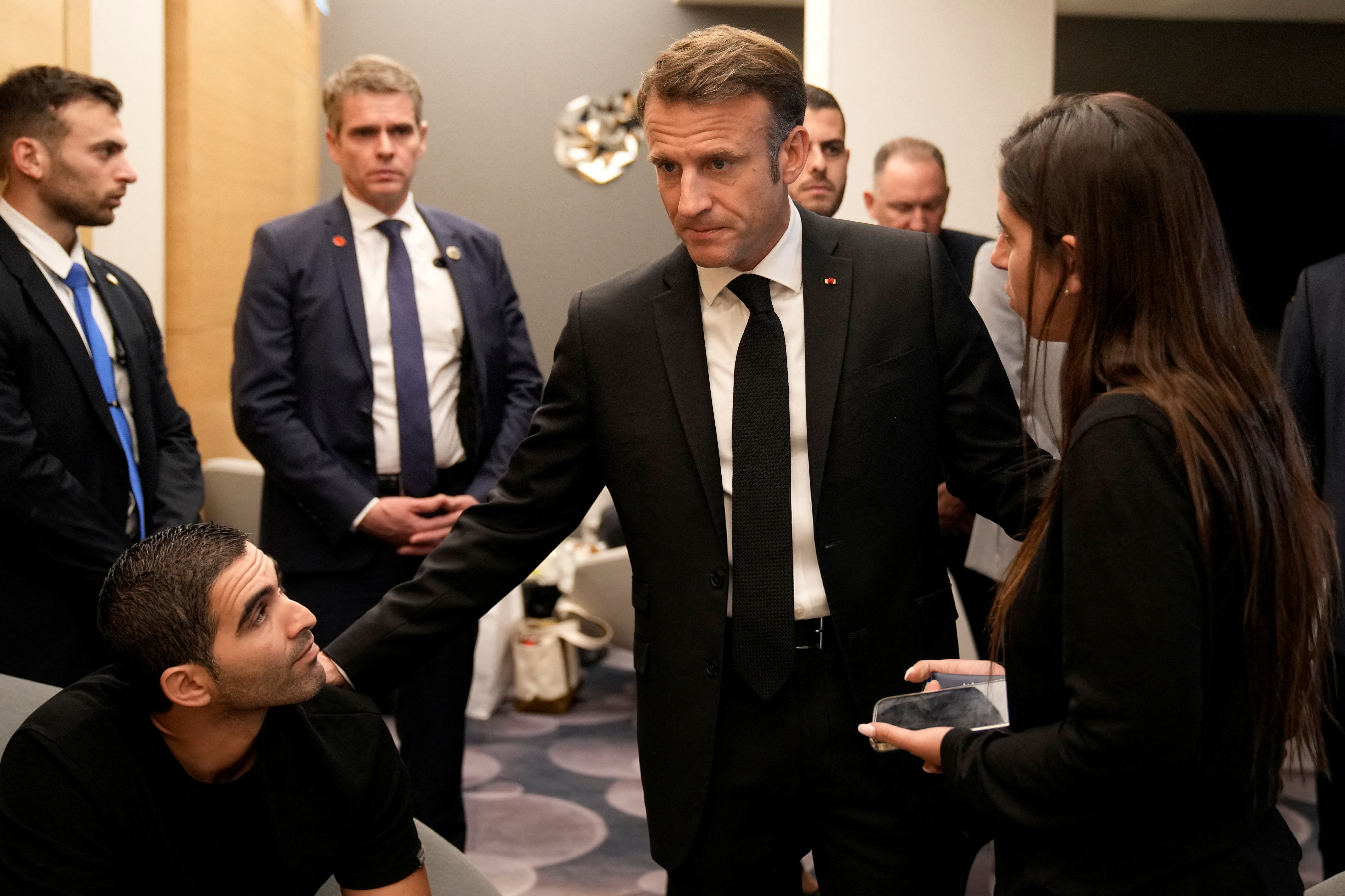 French President Emmanuel Macron, center, meets with Israeli-French nationals during his visit to Israel.