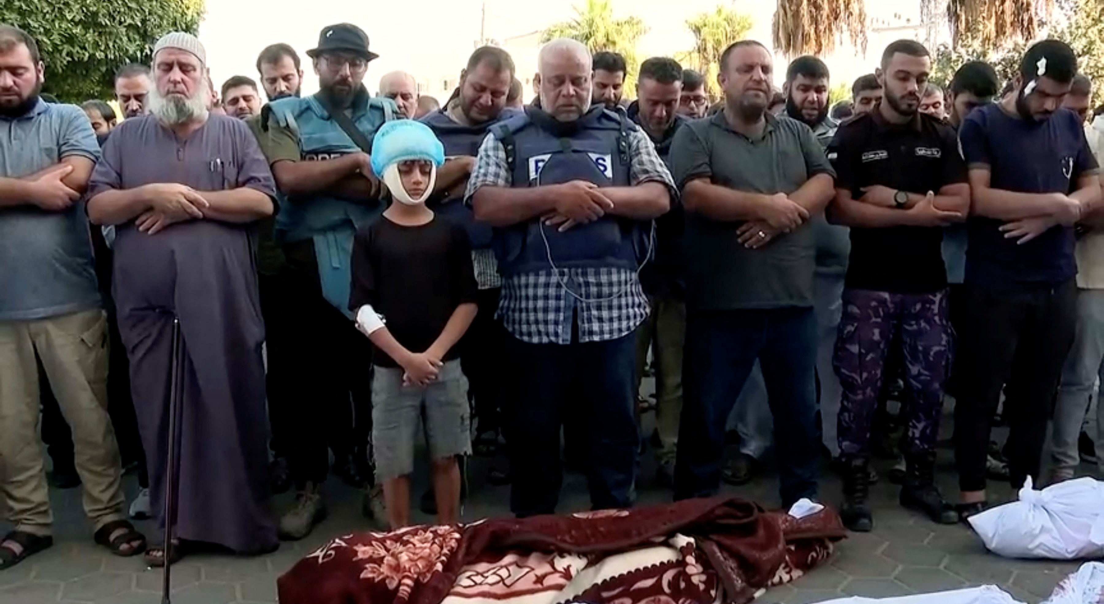 Al Jazeera correspondent, Wael al-Dahdouh attends the funeral of his wife and children, who the network said were killed in an Israeli air strike, in central Gaza Strip, in this still image taken from a video obtained by Reuters on October 26, 2023