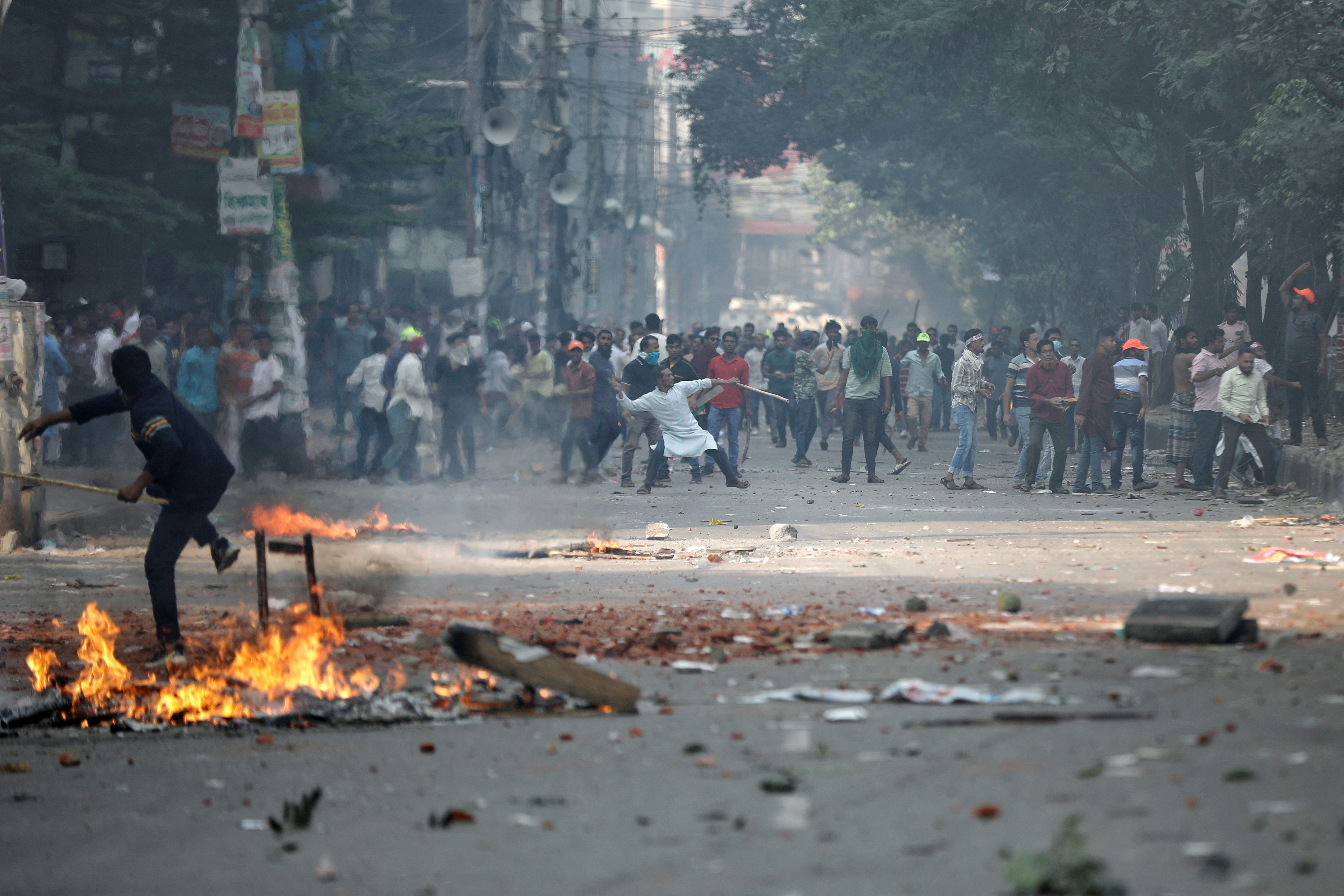 Supporters of Bangladesh Nationalist Party (BNP) throw brickbats towards police during a clash in Dhaka, Bangladesh, on October 28, 2023. REUTERS/Mohammad Ponir Hossain