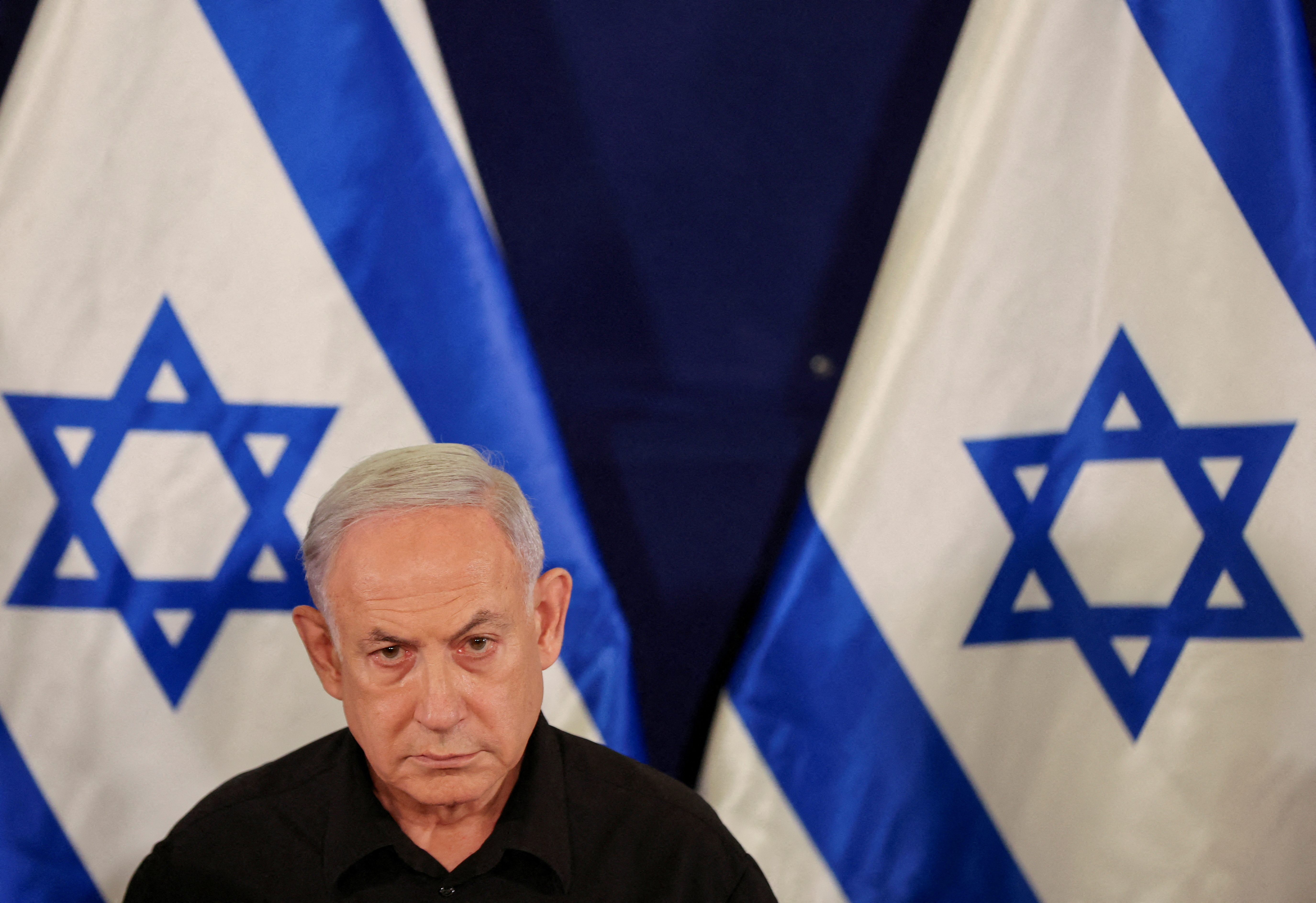 Israeli Prime Minister Benjamin Netanyahu holds a press conference with Defense Minister Yoav Gallant and Cabinet Minister Benny Gantz (not pictured) in the Kirya military base in Tel Aviv , Israel , 28 October 2023. ABIR SULTAN POOL/Pool via REUTERS