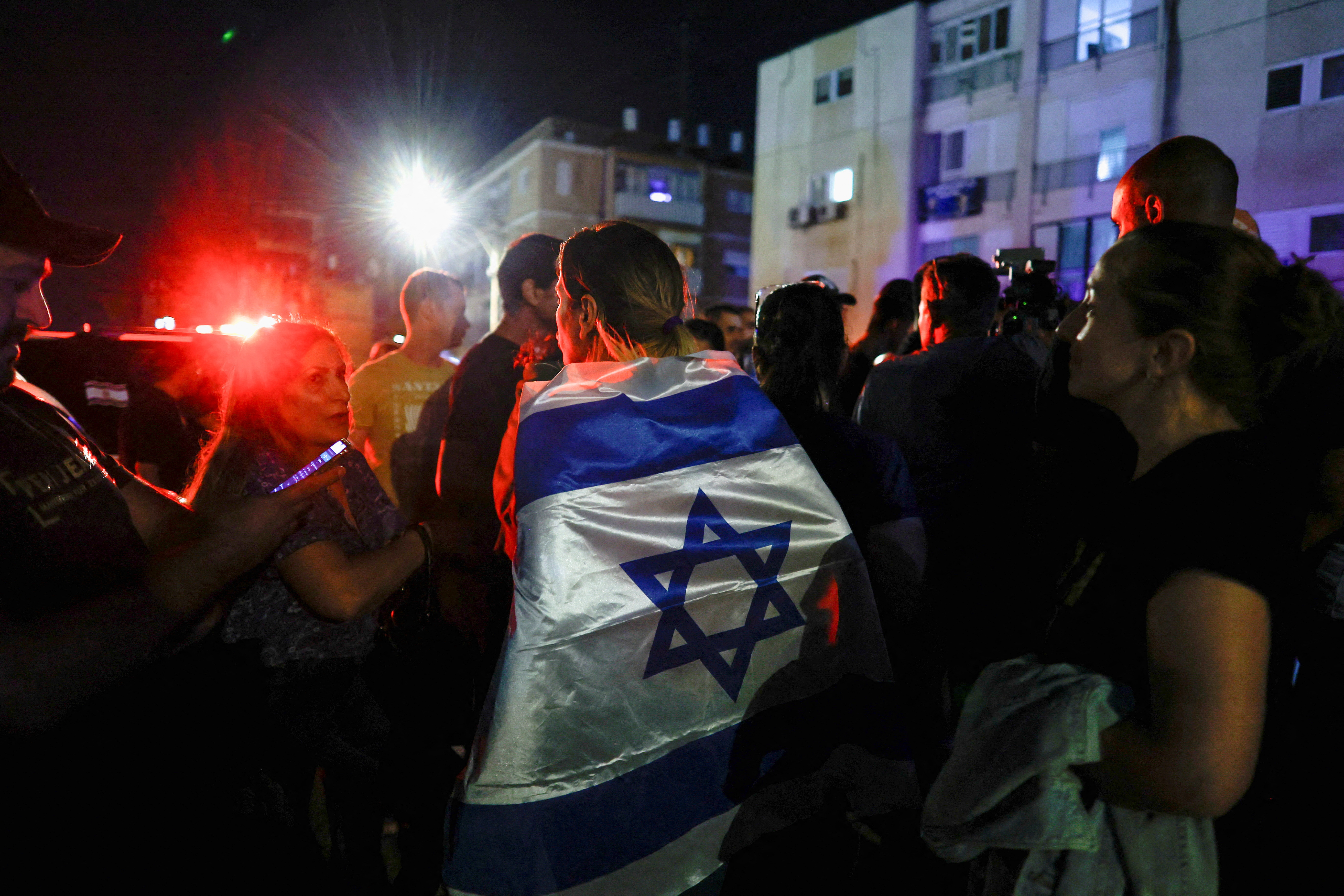 People gather after the news that Israeli soldier Ori Megidish, who was taken hostage by Hamas, was released following an Israeli ground operation inside Gaza according to the Israeli army, near her home in Kiryat Gat, Israel October 30, 2023. REUTERS/Evelyn Hockstein REFILE - QUALITY REPEAT