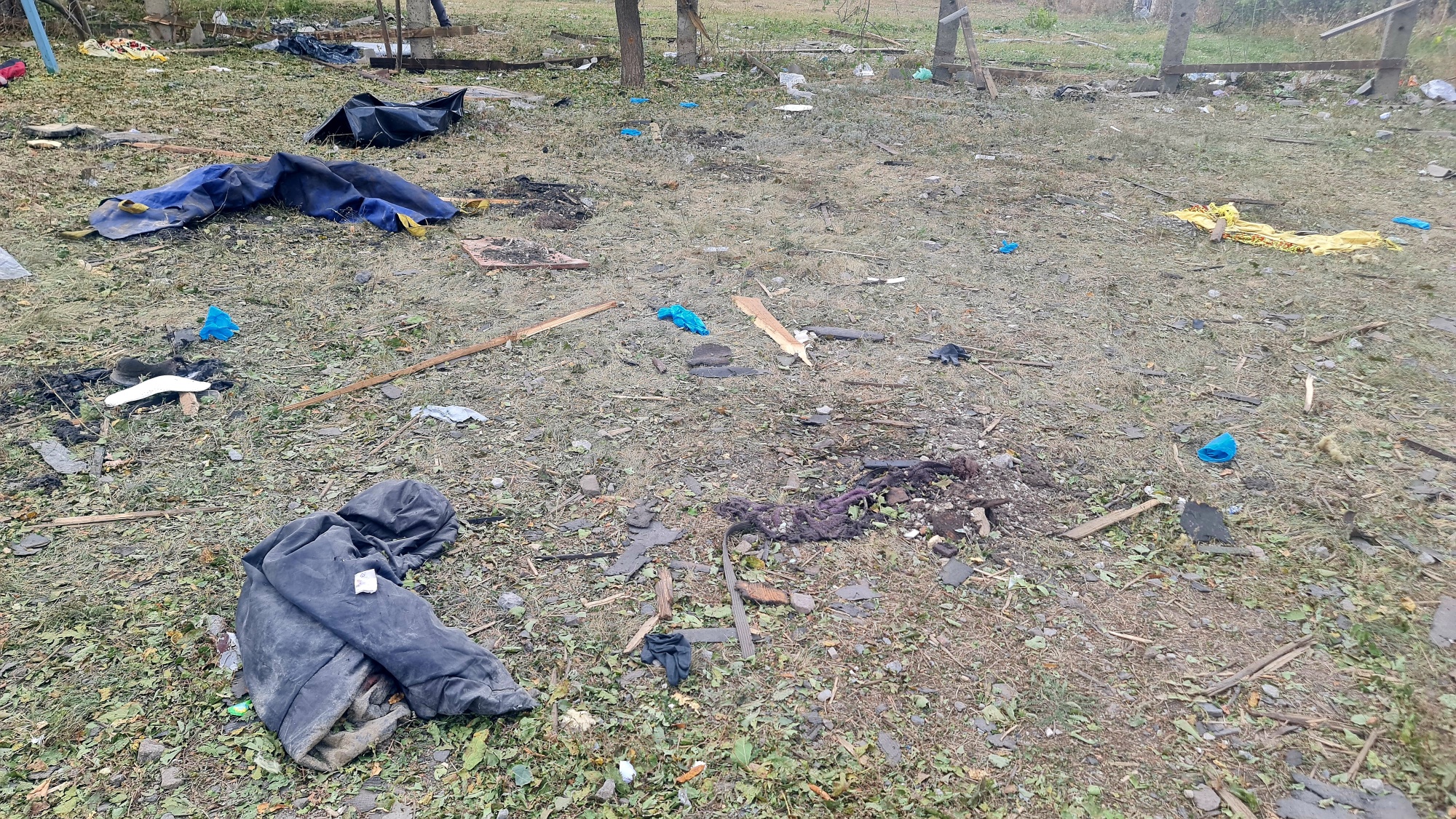 A photo of cloth and debris on grass.