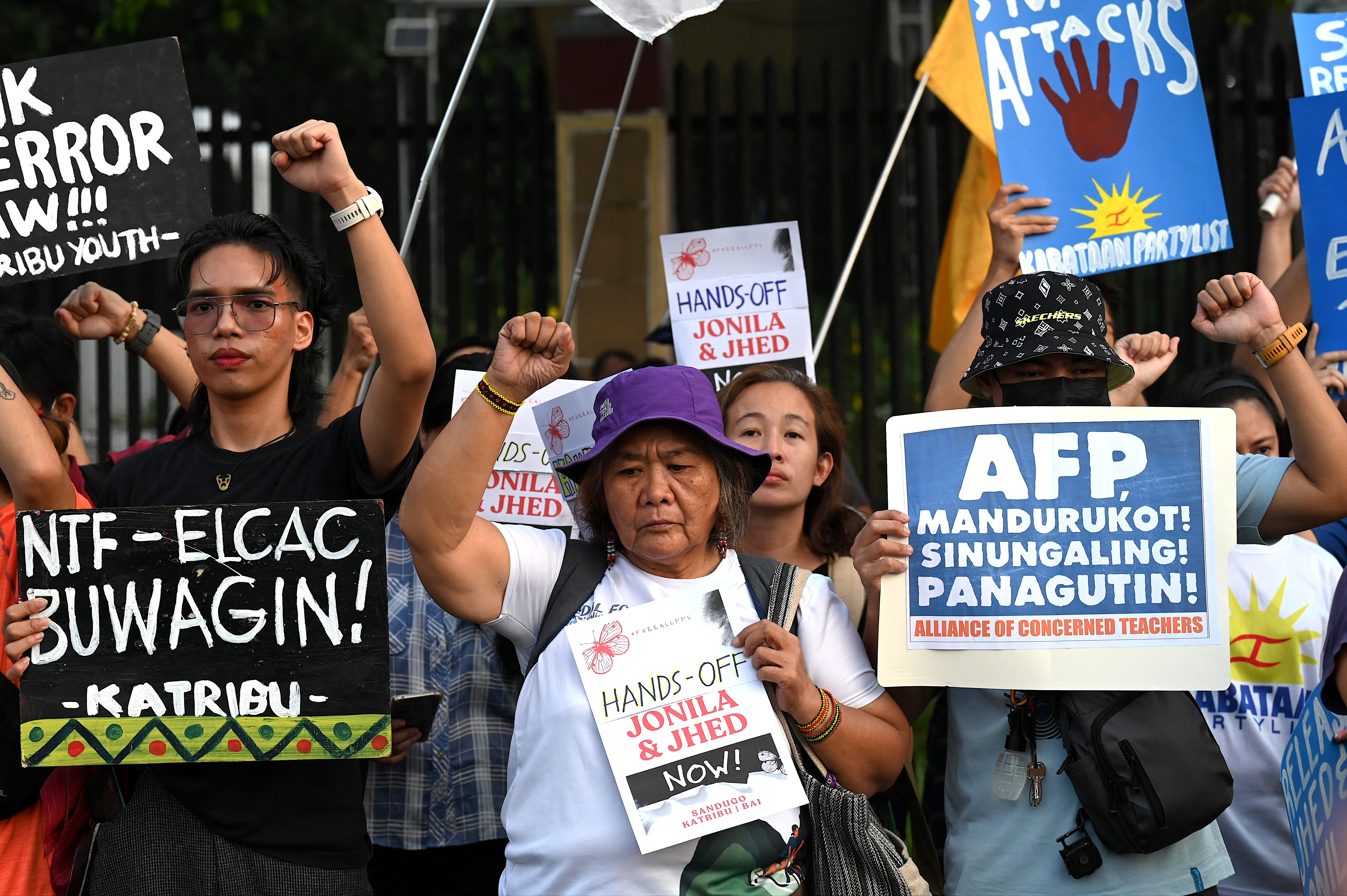 Supporters of Tamano and Castro holding placards and punching the air