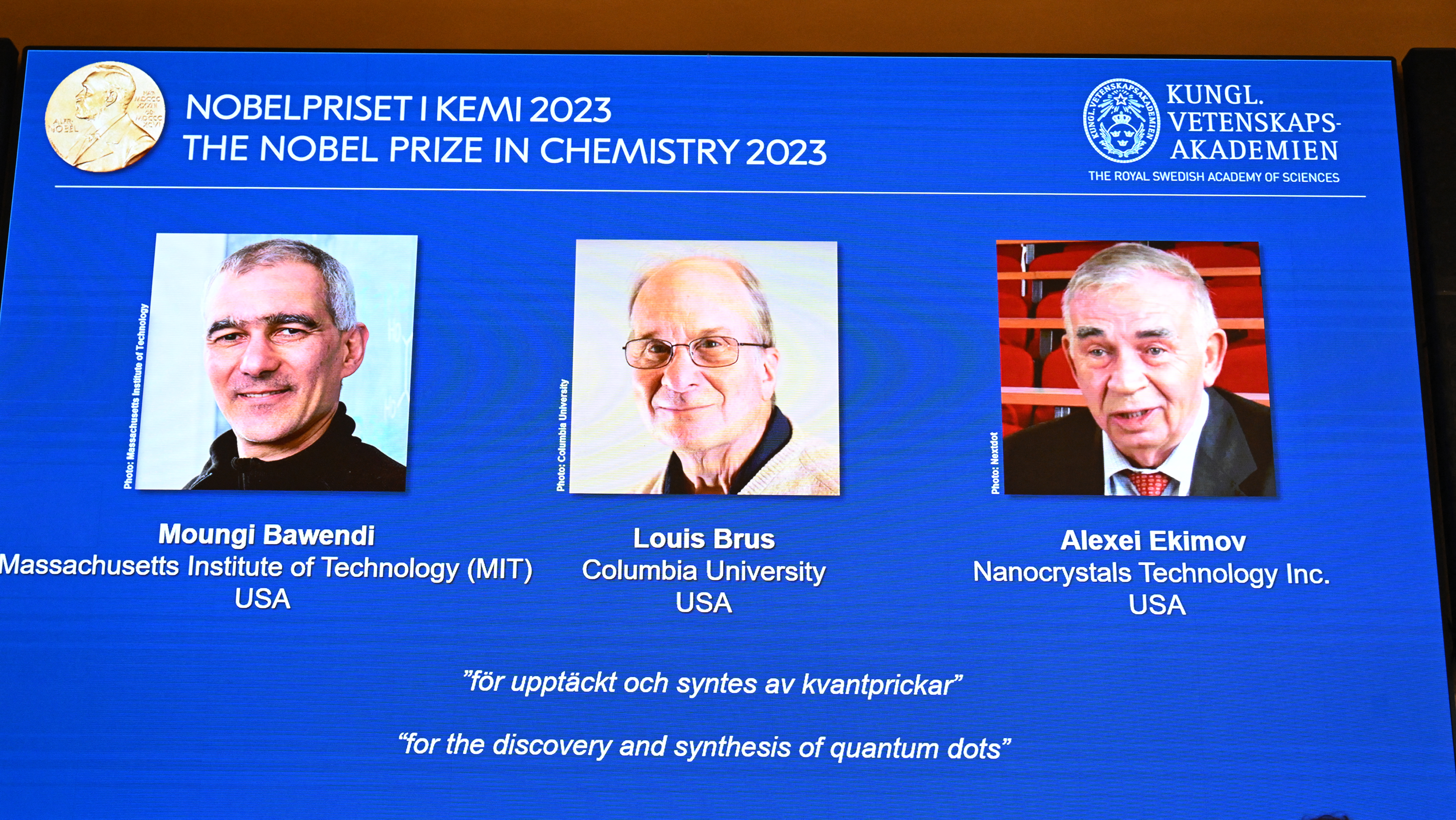 Pictures of American chemists Moungi Bawendi and Louis Brus and Russian physicist Alexei Ekimov appear on a screen during the announcement of the winners of the 2023 Nobel Prize in Chemistry in Stockholm, Sweden