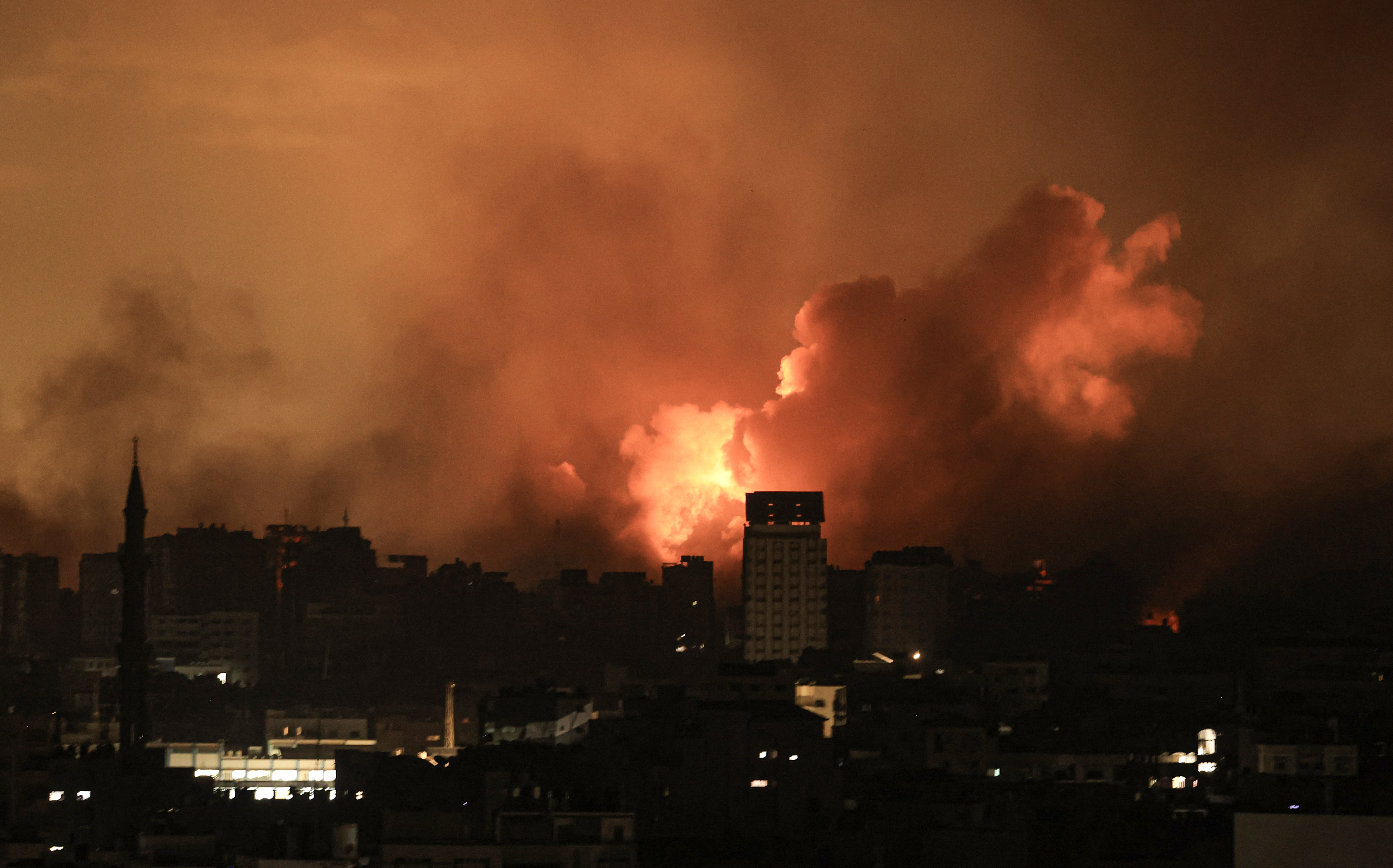 A ball of fire erupts in Gaza City after an Israeli air strike