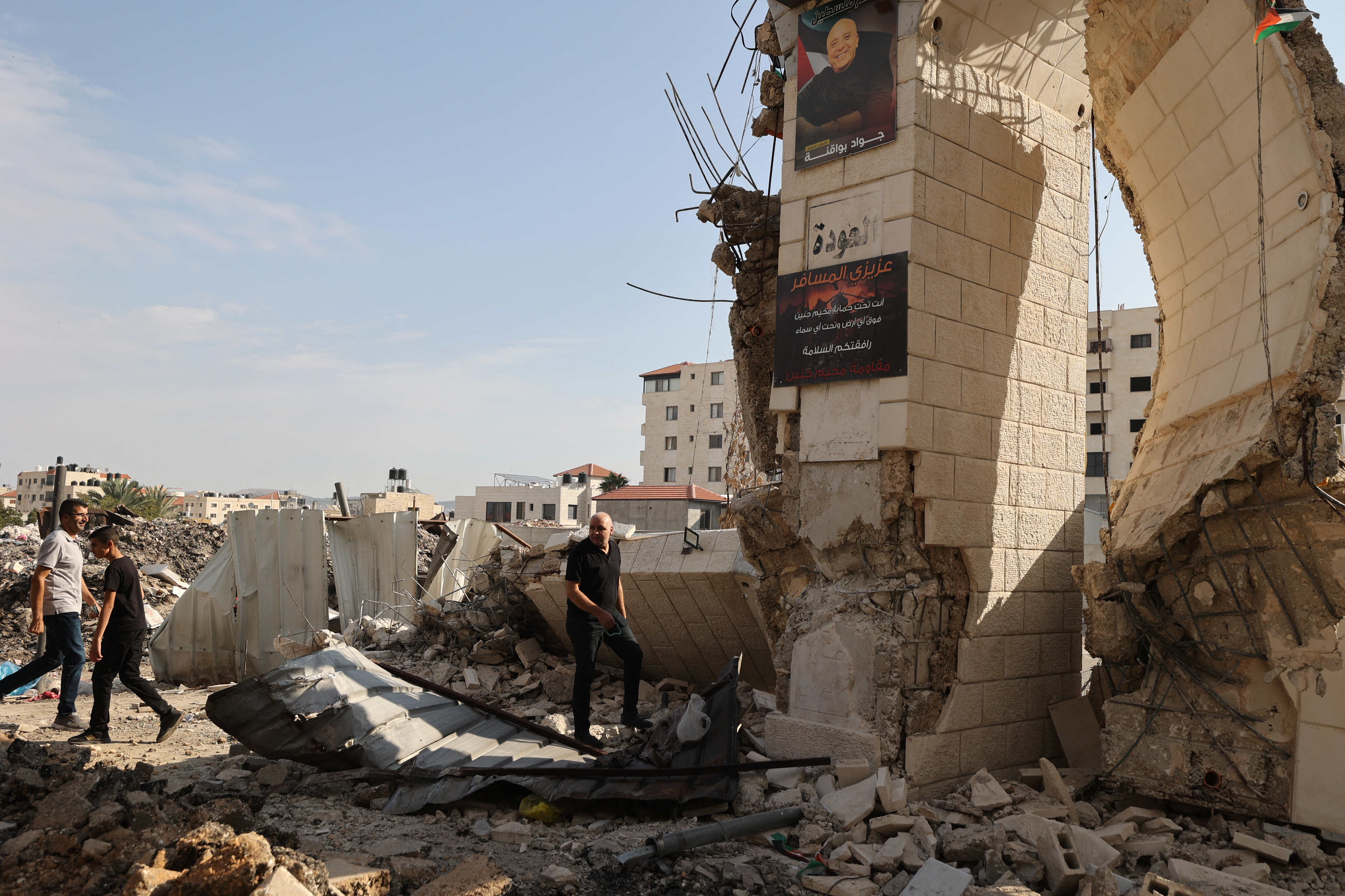 Palestinians survey the destruction following an Israeli military raid on the Jenin