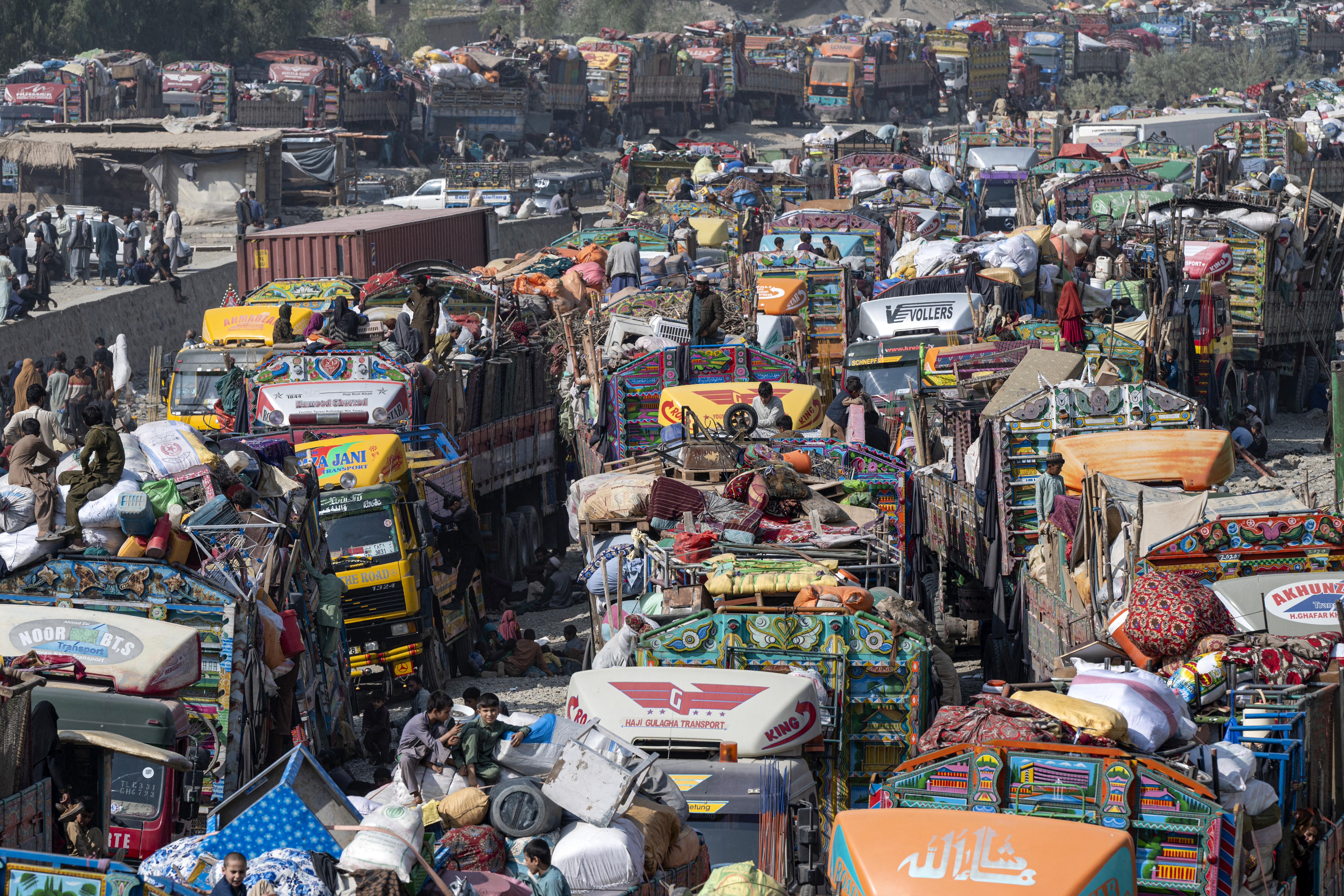 Afghan refugees arrive in trucks from Pakistan at the Afghanistan-Pakistan Torkham border in Nangarhar province