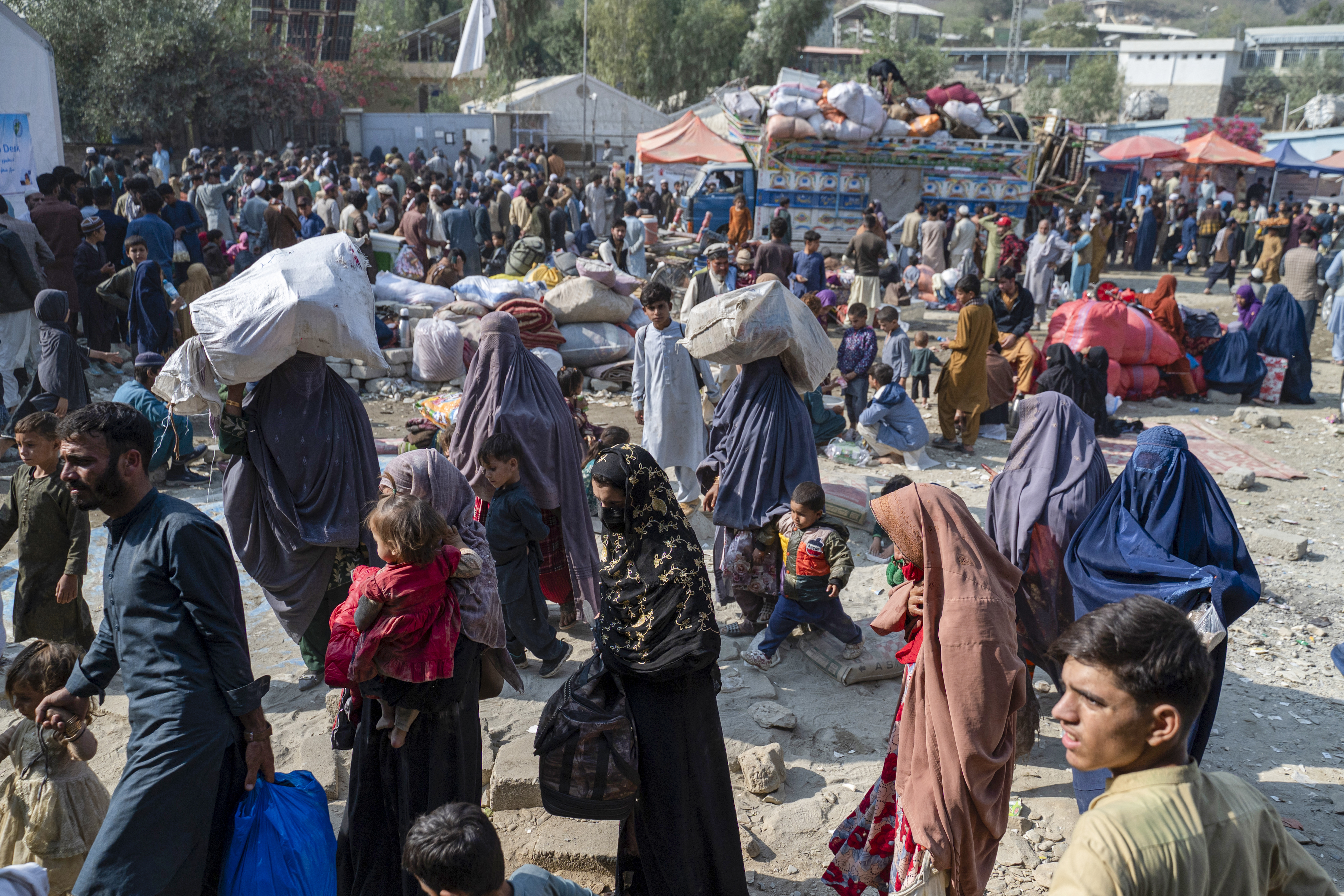 Afghan refugees arrive in trucks from Pakistan at the Afghanistan-Pakistan Torkham border in Nangarhar province