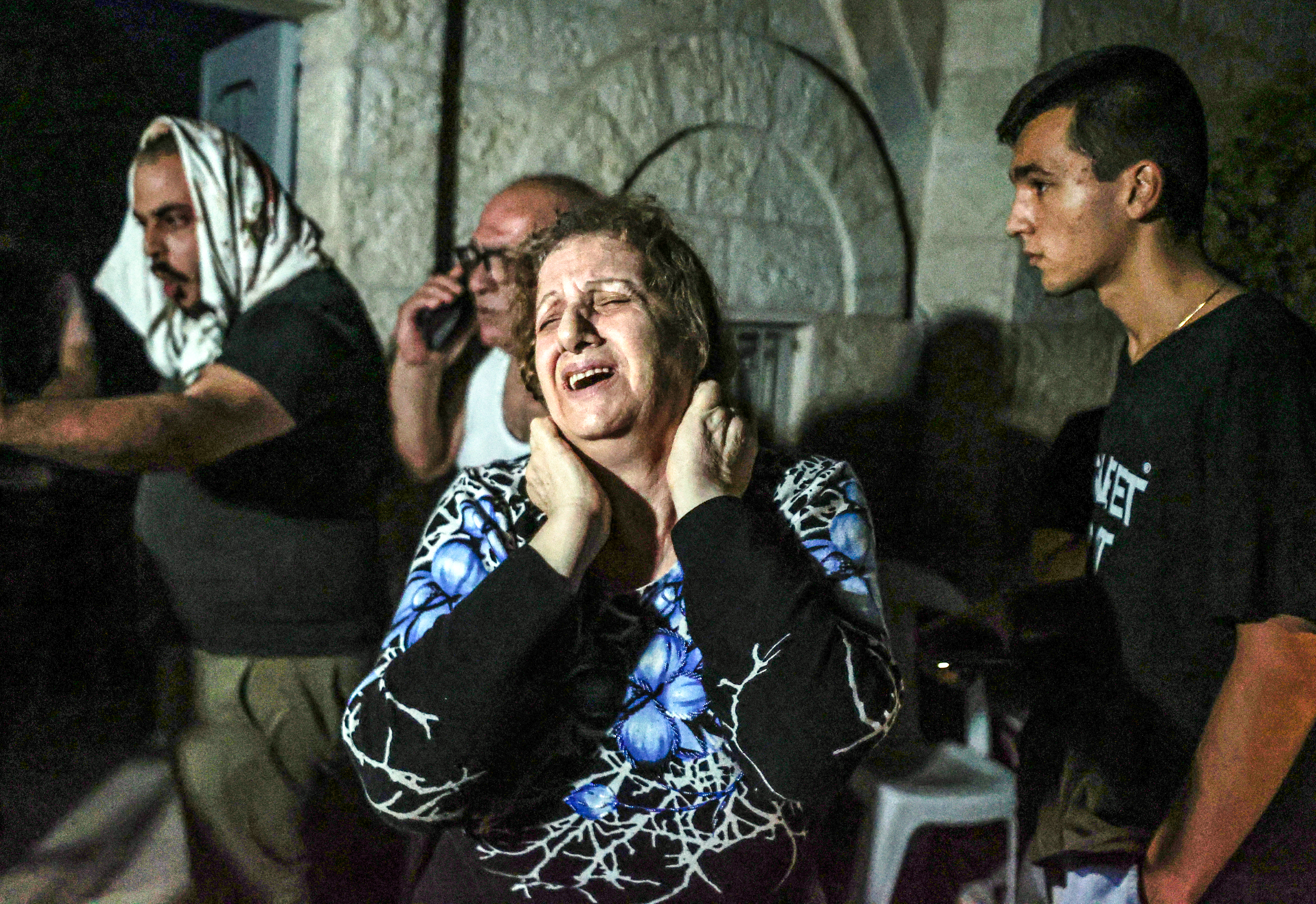 A woman cries at the Greek Orthodox Church after an Israeli attack