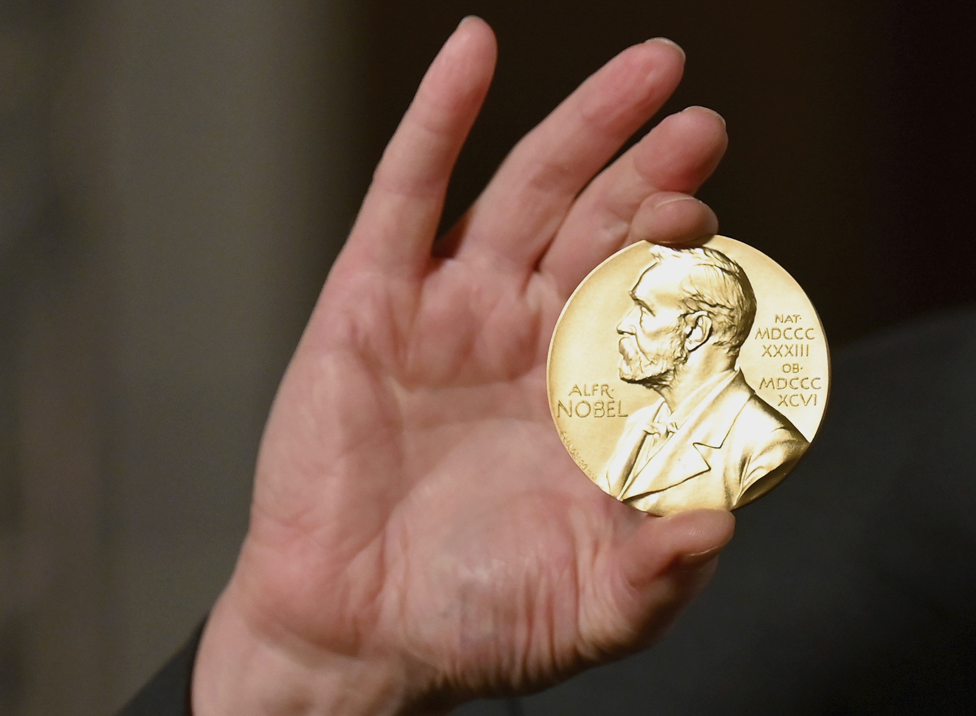 FILE - In this Tuesday, Dec. 8, 2020 file photo a Nobel medal is held up during a ceremony in New York. The Nobel Prize for Chemistry will be announced on Wednesday Oct. 6, 2021. (Angela Weiss/Pool Photo via AP, File)