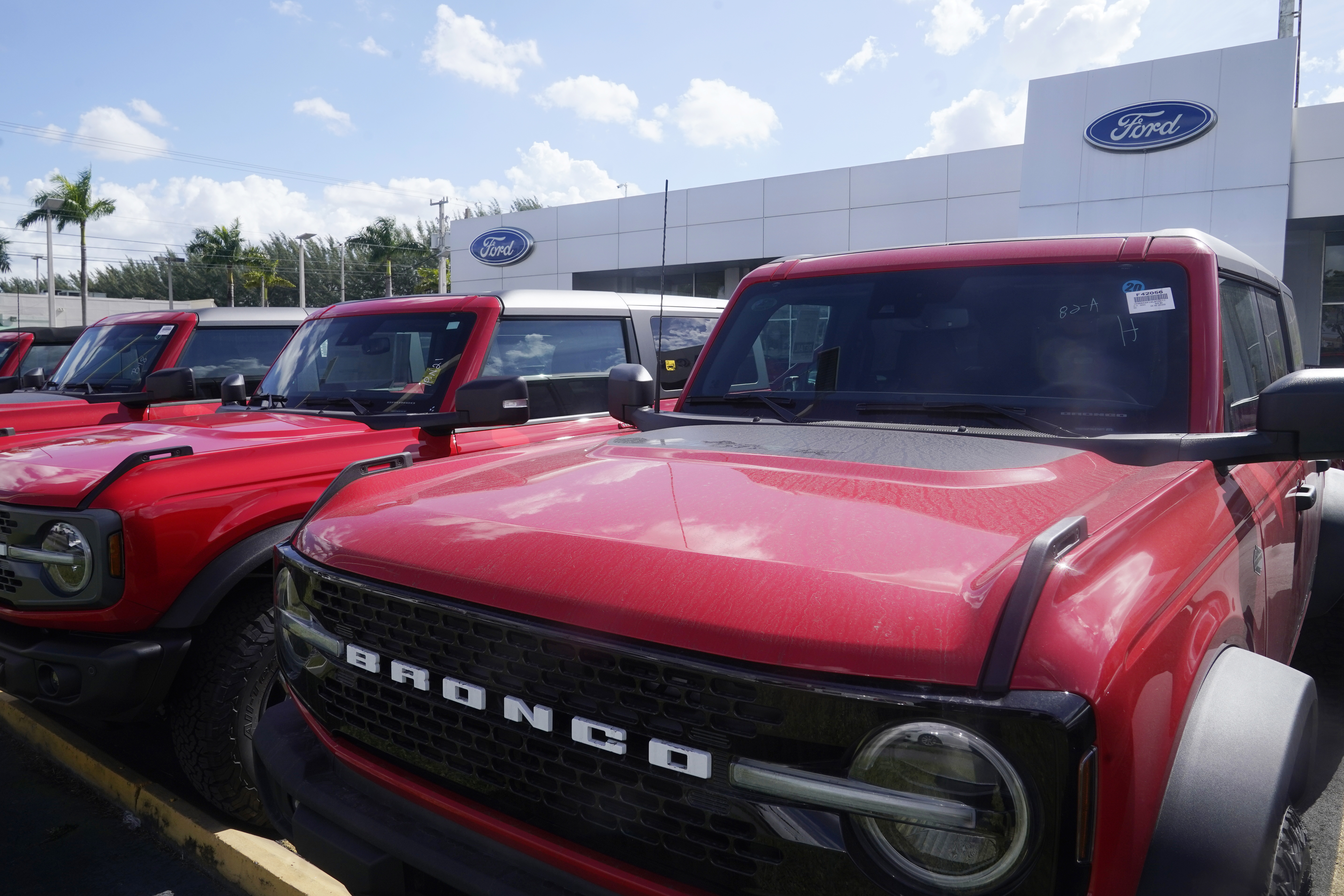 Ford Broncos line the the front of Gus Machado's Ford dealership, Monday, Jan. 23, 2023, in Hialeah, Fla. U.S.