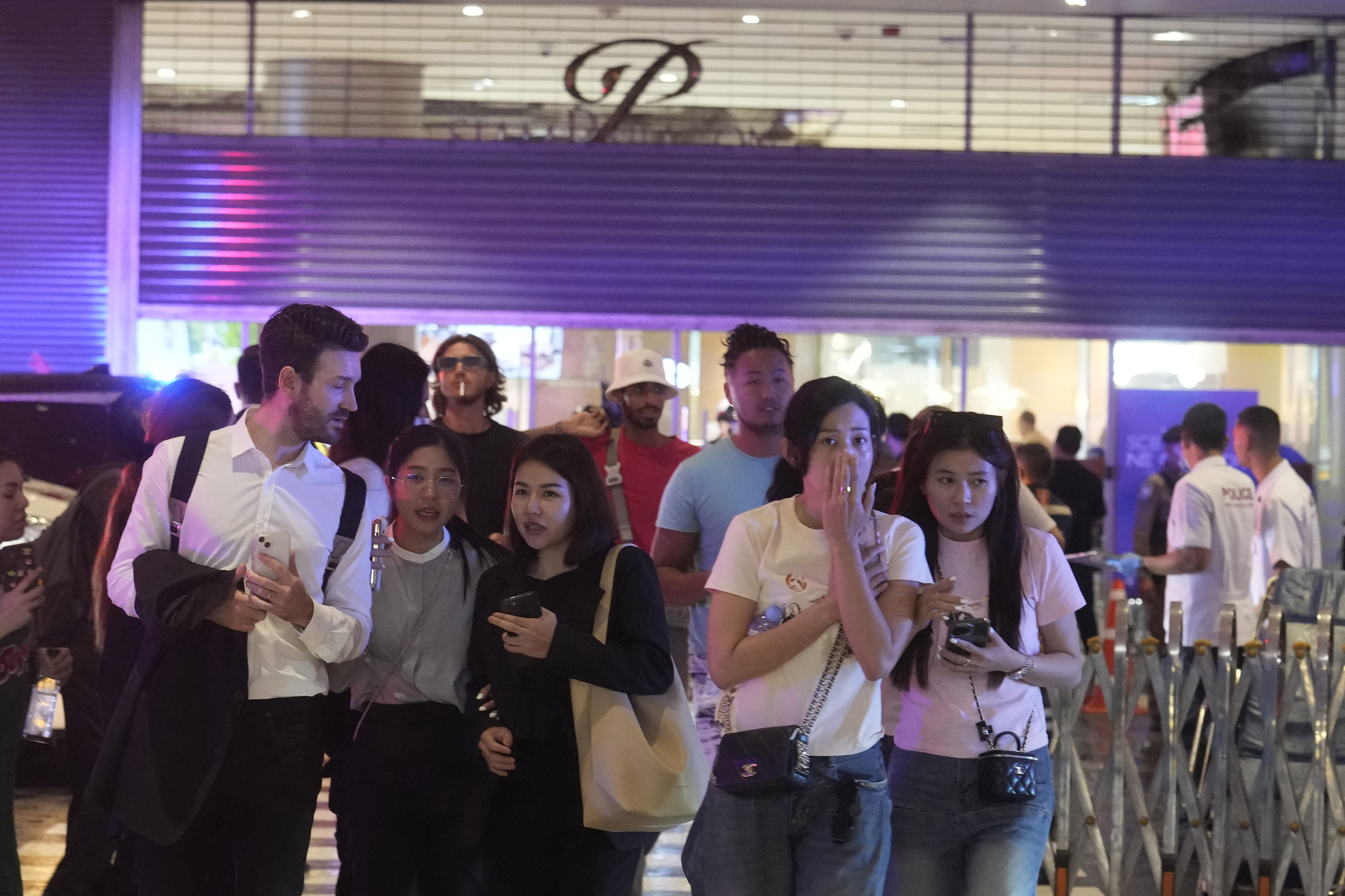 Visitors evacuate from a shopping mall in Bangkok,