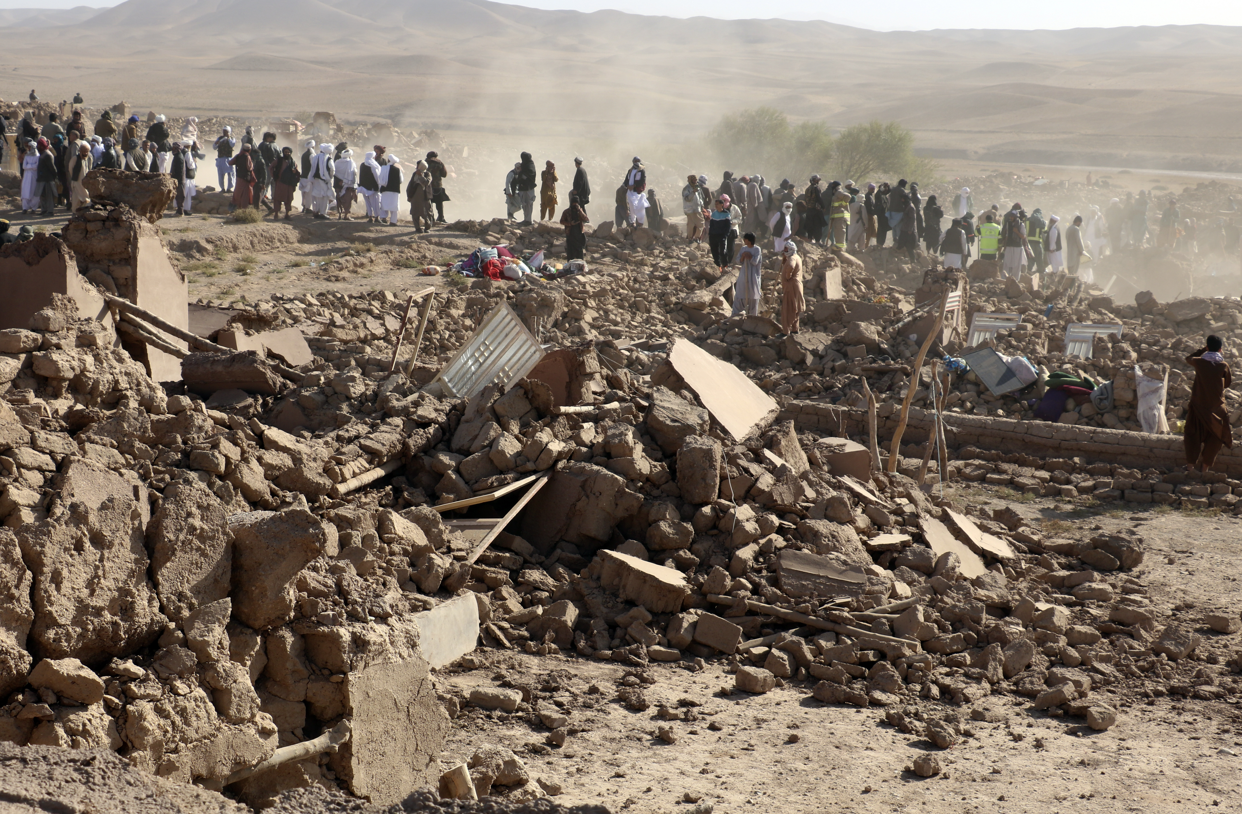 Afghan men search for victims after an earthquake in Zenda Jan district in Herat province, of western Afghanistan