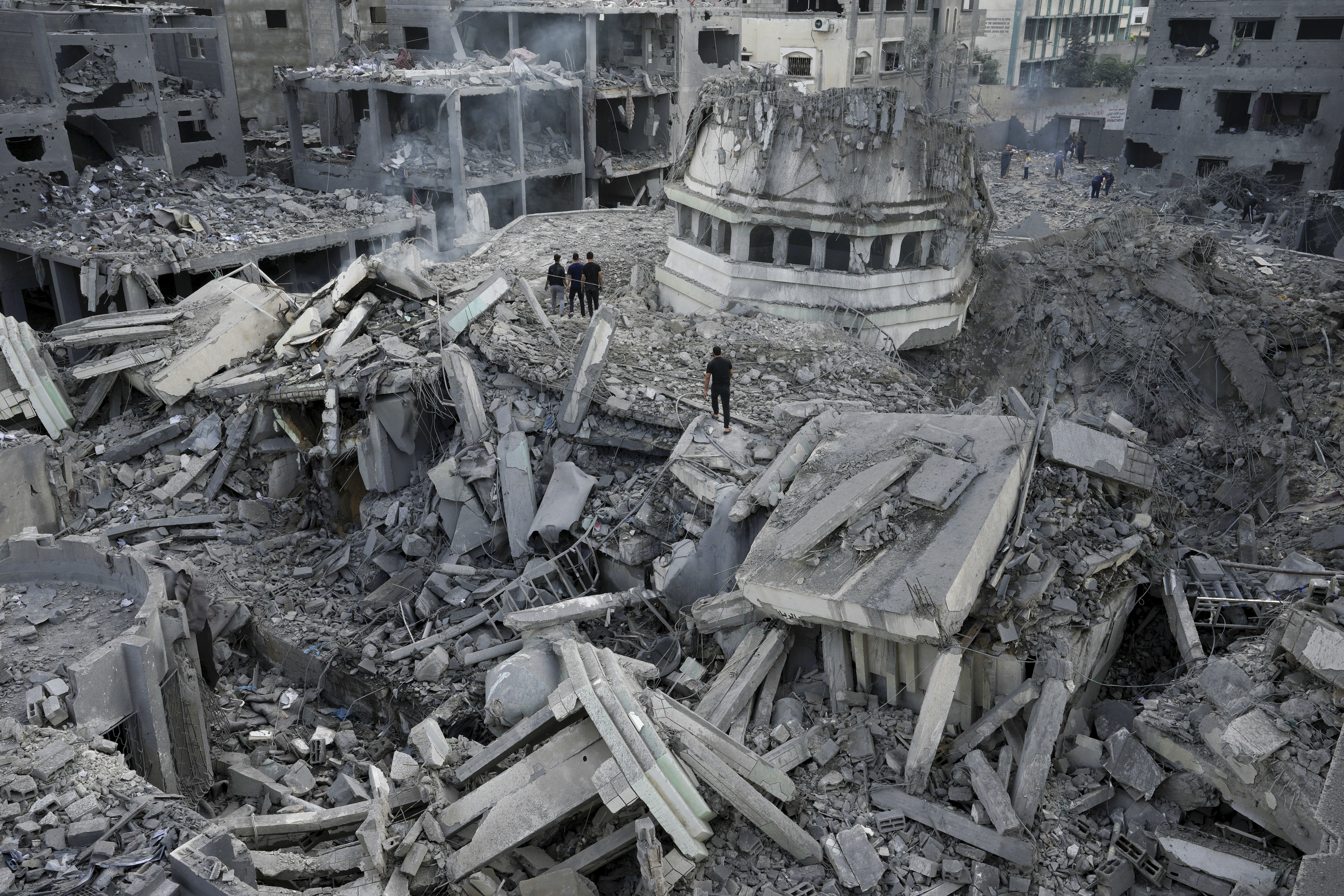 Palestinians inspect the rubble of the Yassin Mosque destroyed after it was hit by an Israeli airstrike at Shati refugee camp in Gaza City
