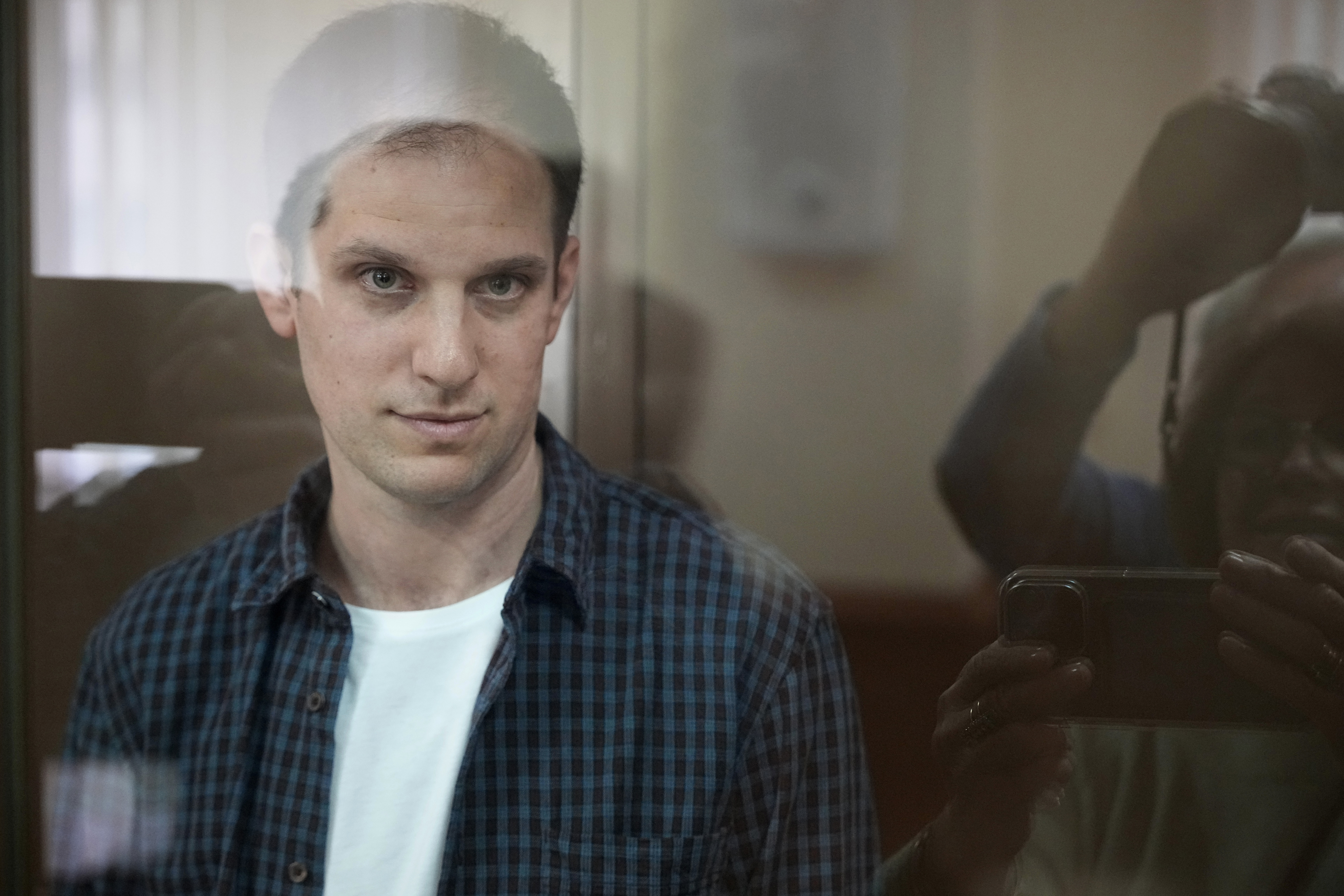 US journalist Evan Gershkovich pictured inside a glass box in a Moscow court