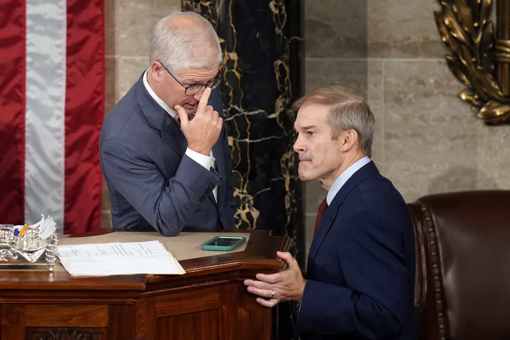 Jim Jordan speaks with a fellow Republican
