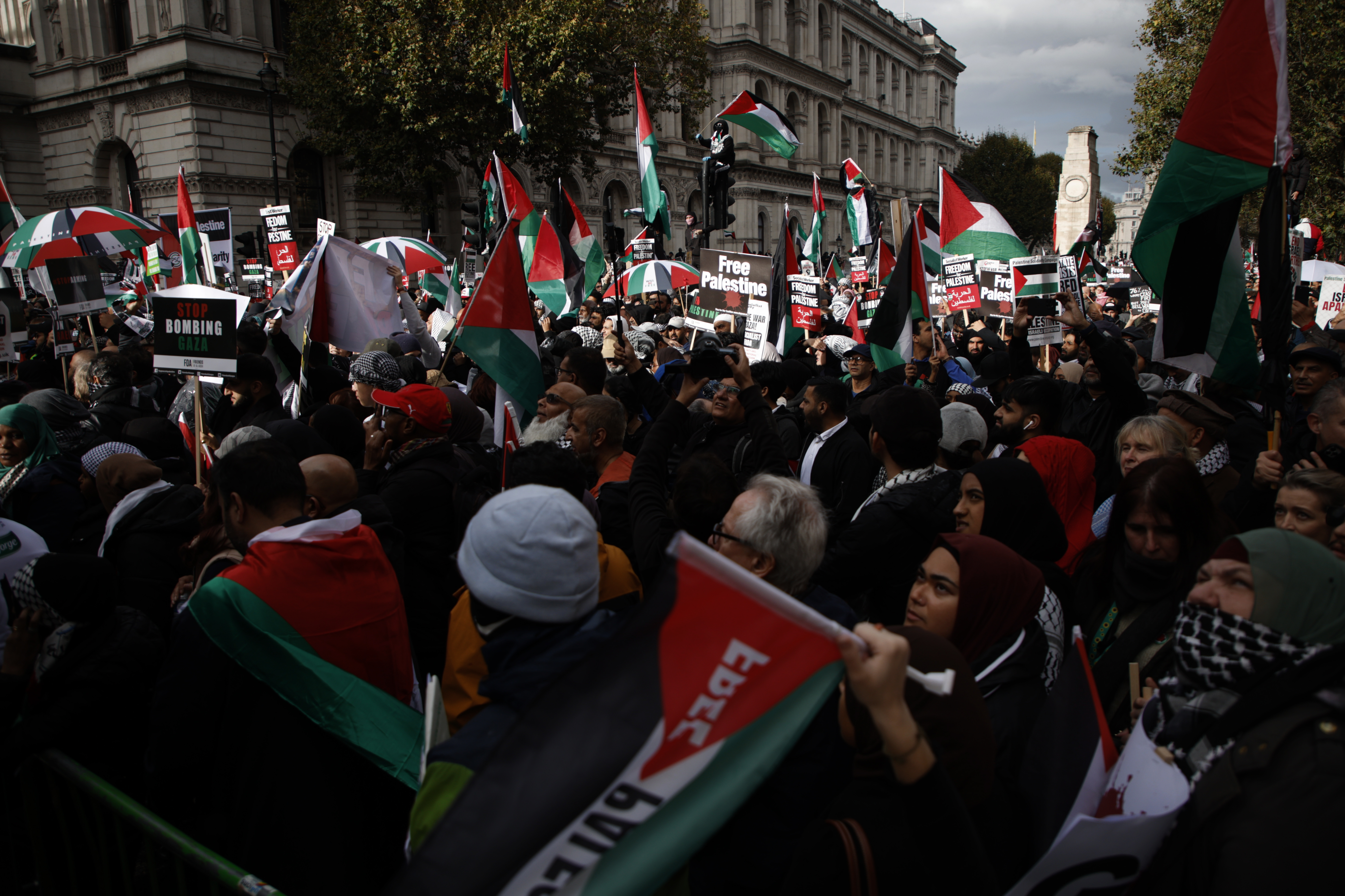 Demonstrators hold up flags and placards during a pro Palestinian demonstration in London