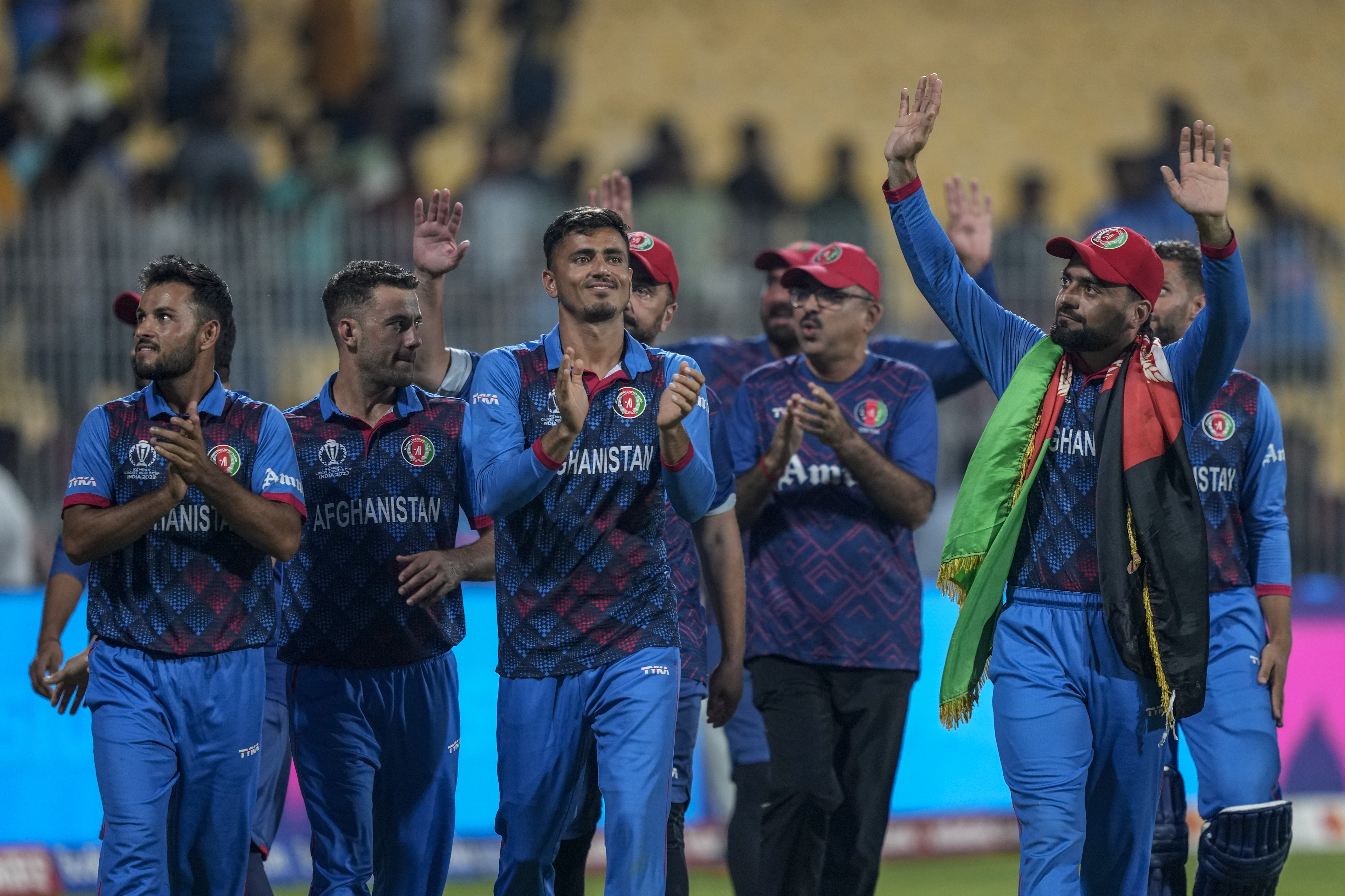 Afghanistan's players acknowledge the crowd after winning their match against Pakistan during the ICC Men's Cricket World Cup in Chennai, India