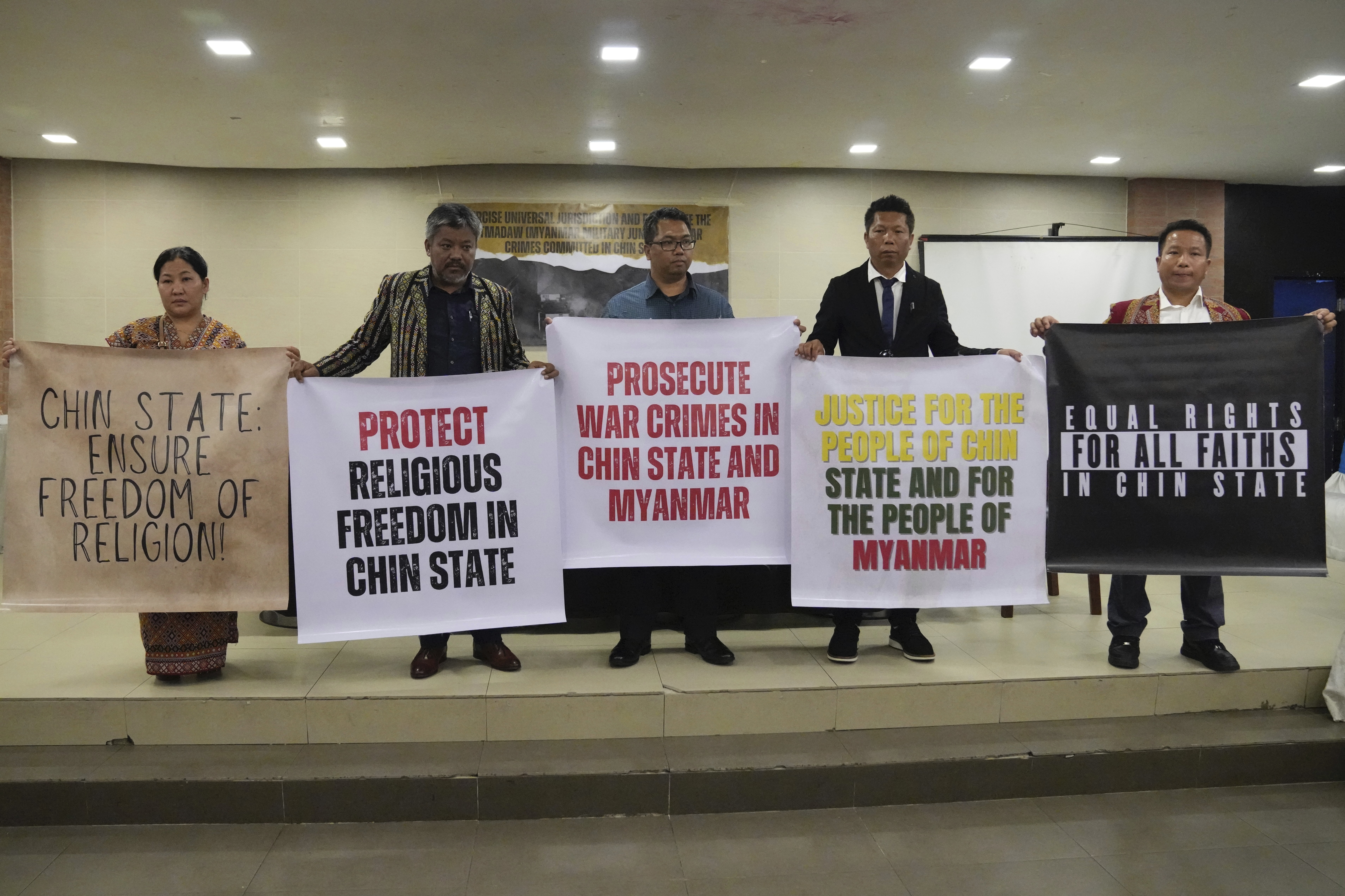 Families hold posters calling for protection of ethnic Chin civilians from Myanmar