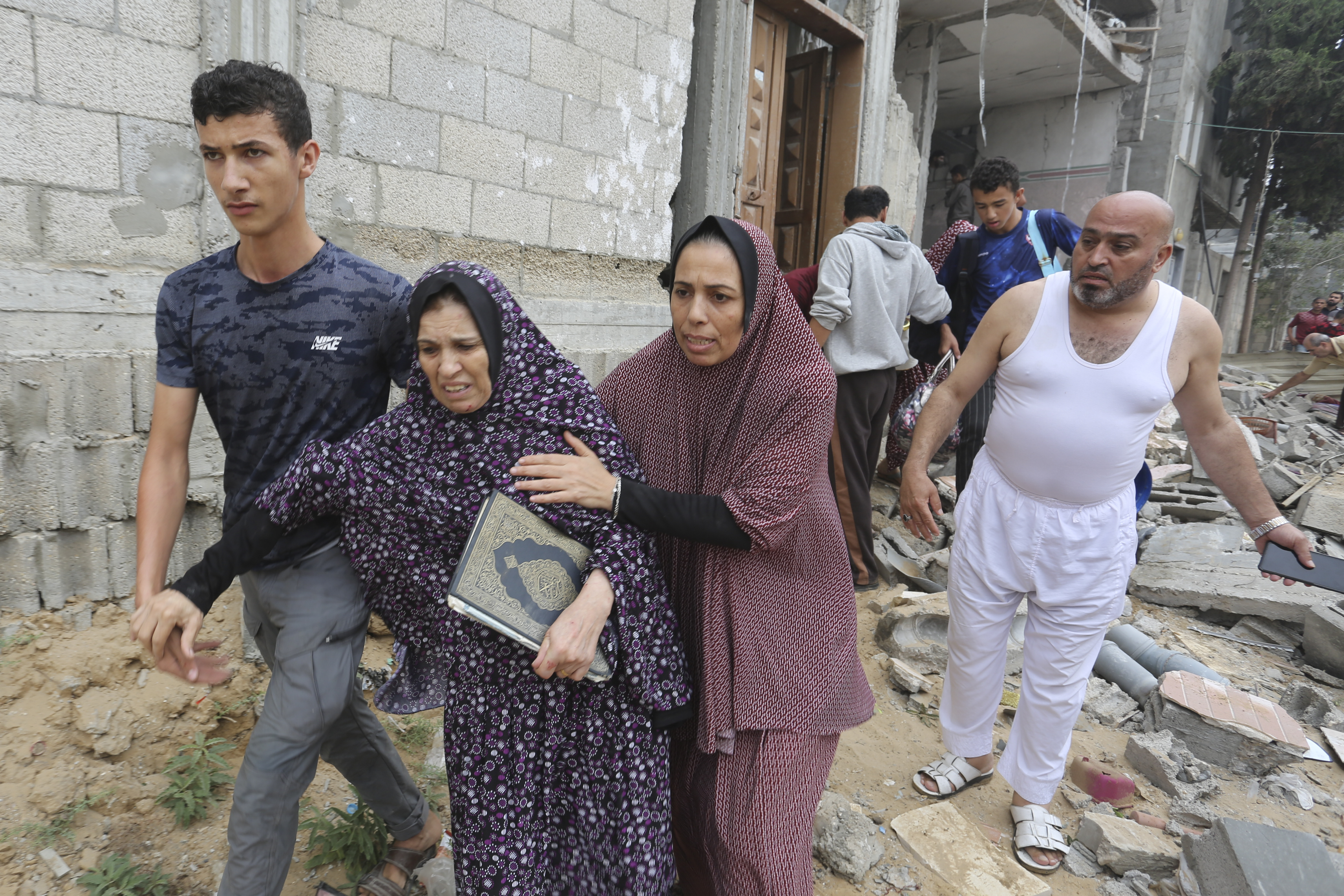 Palestinians evacuate a building destroyed in the Israeli bombardment of the Gaza Strip in Rafah on Sunday