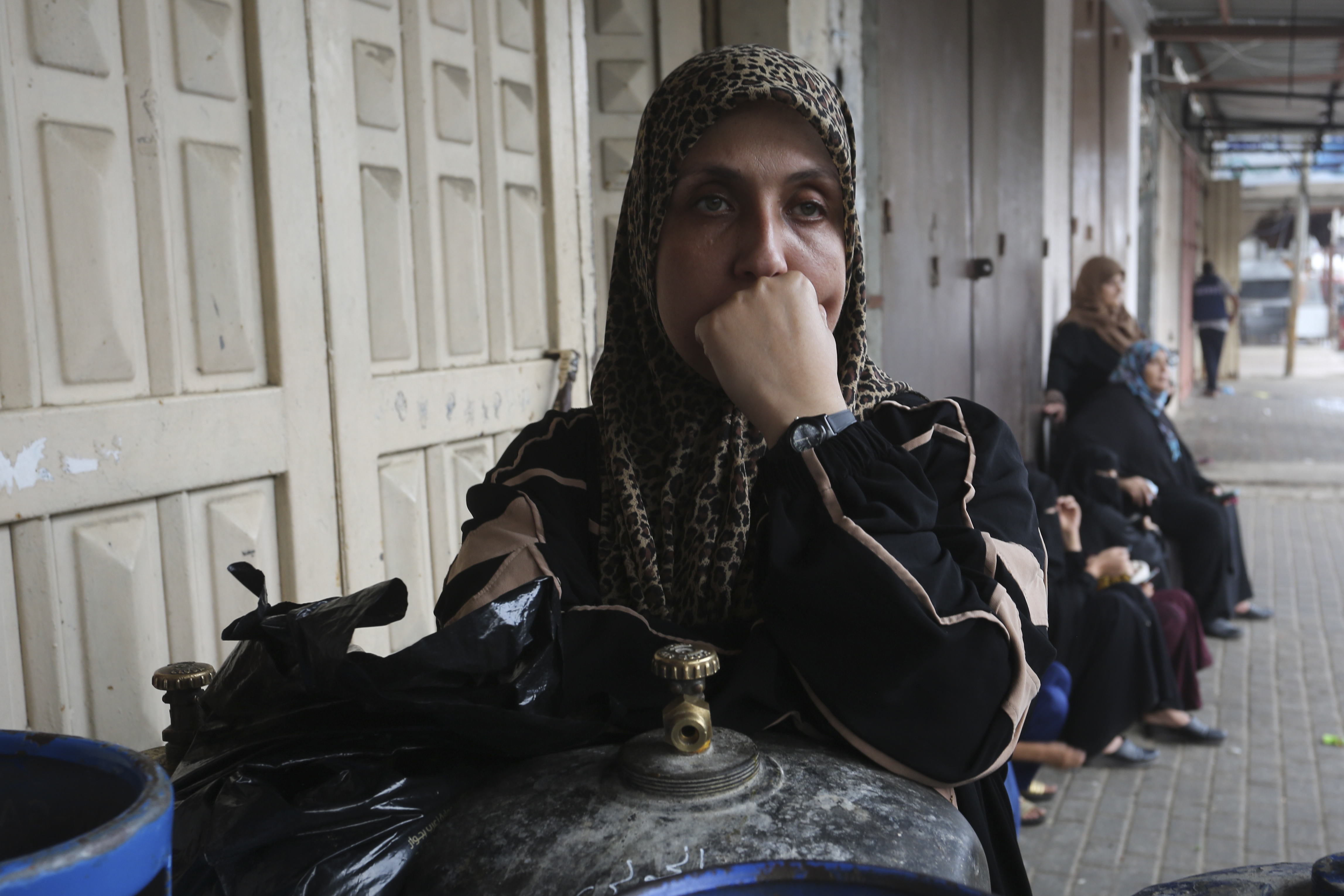 Palestinians wait to buy bread during the ongoing bombardment of the Gaza Strip in Rafah on Sunday,