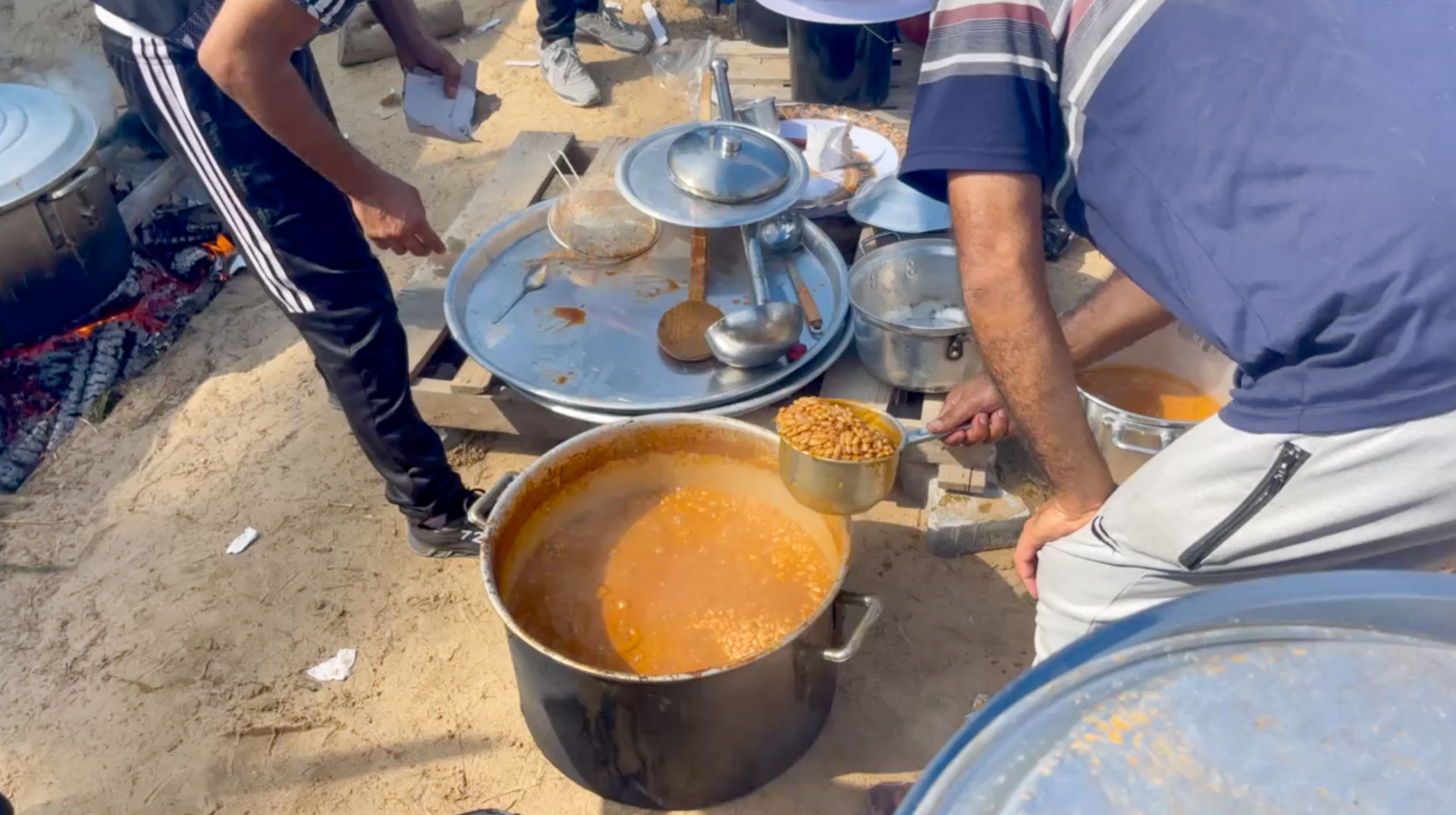 Rice and beans cooked outside for displaced families