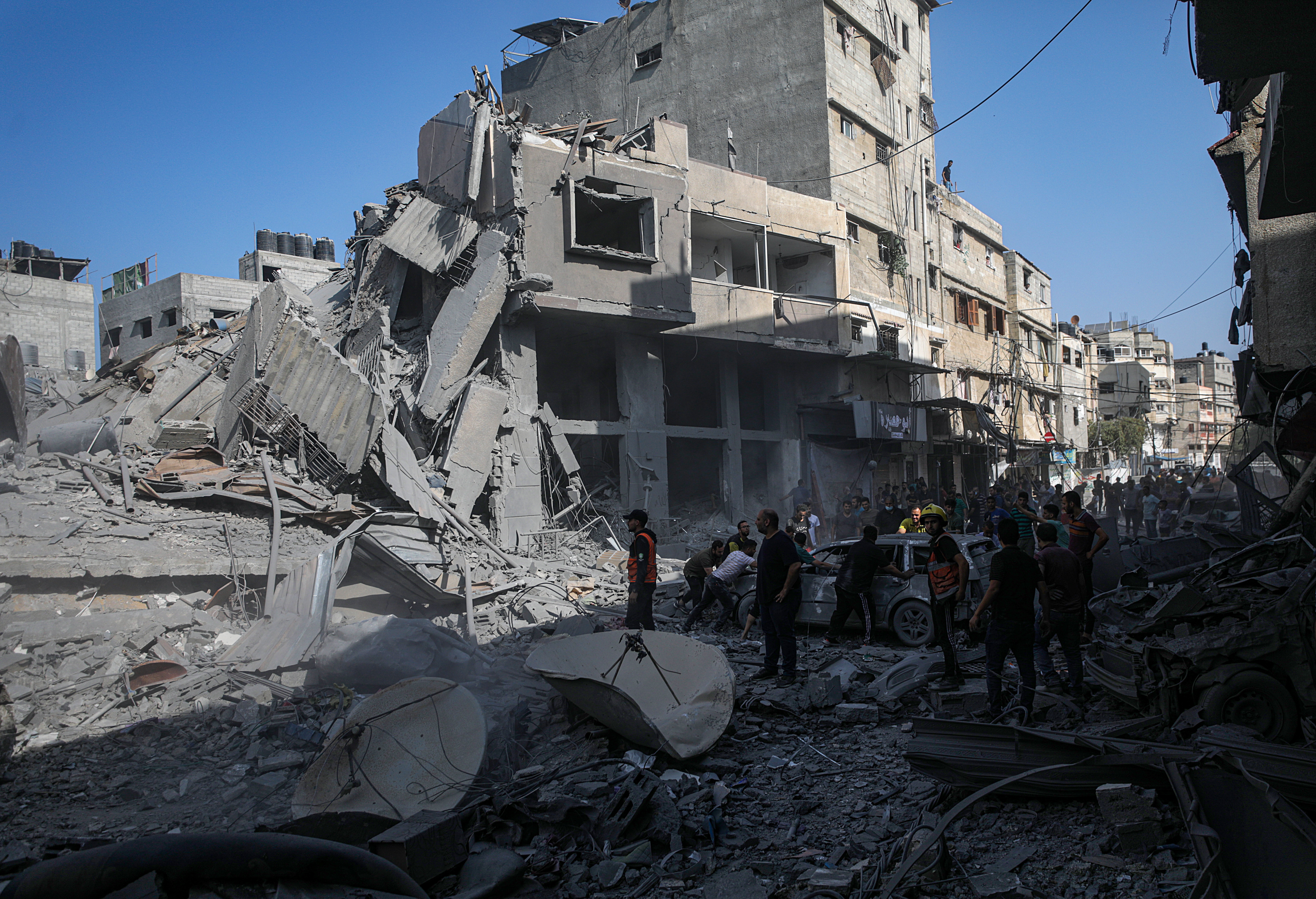 Palestinians search for bodies and survivors among the rubble of a house following Israeli airstrikes in the northern Gaza Strip