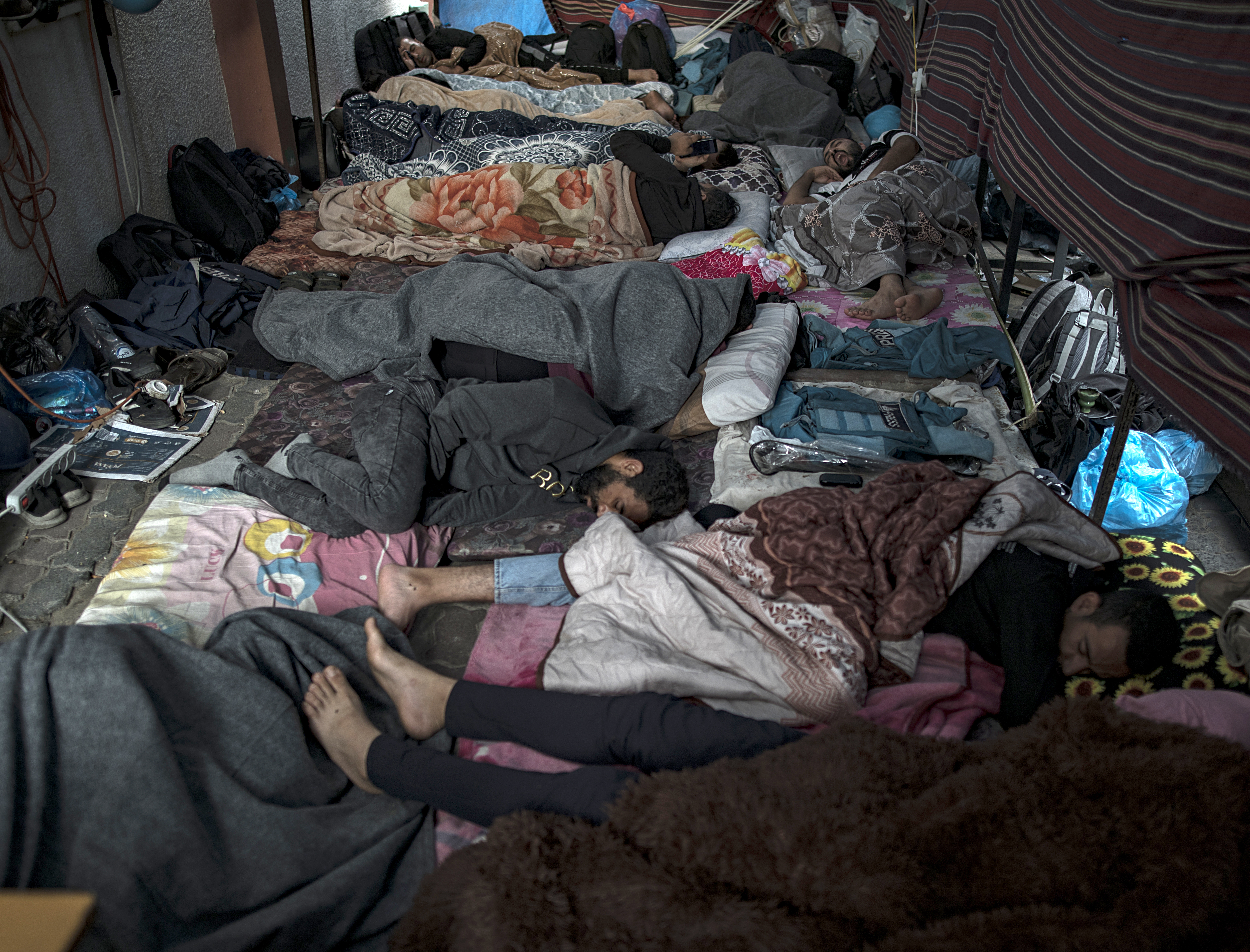 Displaced Palestinians sleep on the hospital floor at Nasser Hospital, in Khan Yunis, southern Gaza Strip.