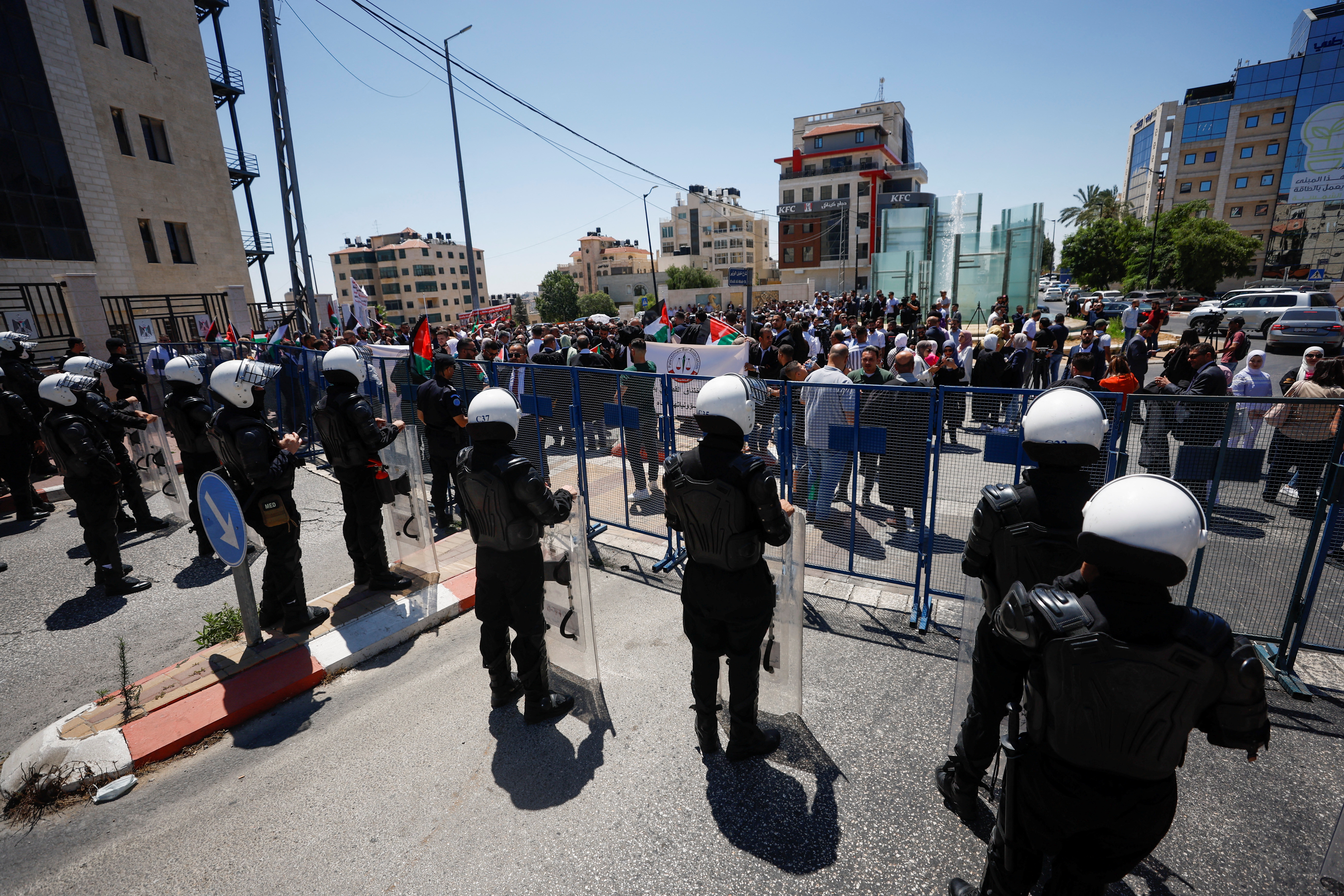 Police officers stand guard as Palestinian lawyers protest against Palestinian Authority's rule by decree and demand a return to normal parliamentary lawmaking, in Ramallah