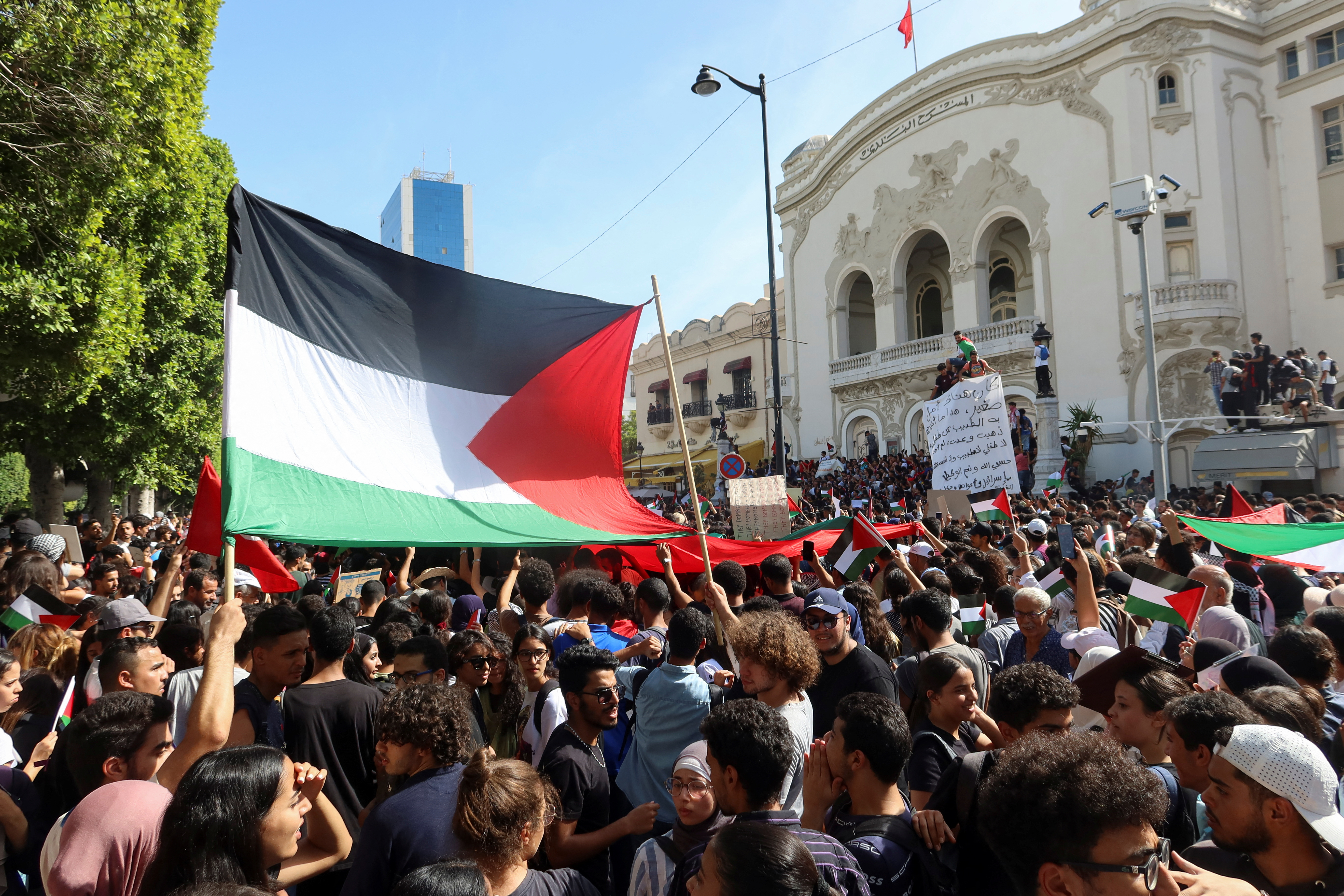 People hold flags during a pro-Palestinian protest after hundreds of Palestinians were killed in a blast at Al-Ahli hospital in Gaza that Israeli and Palestinian officials blamed on each other, in Tunis, Tunisia October 18, 2023. REUTERS/Jihed Abidellaoui
