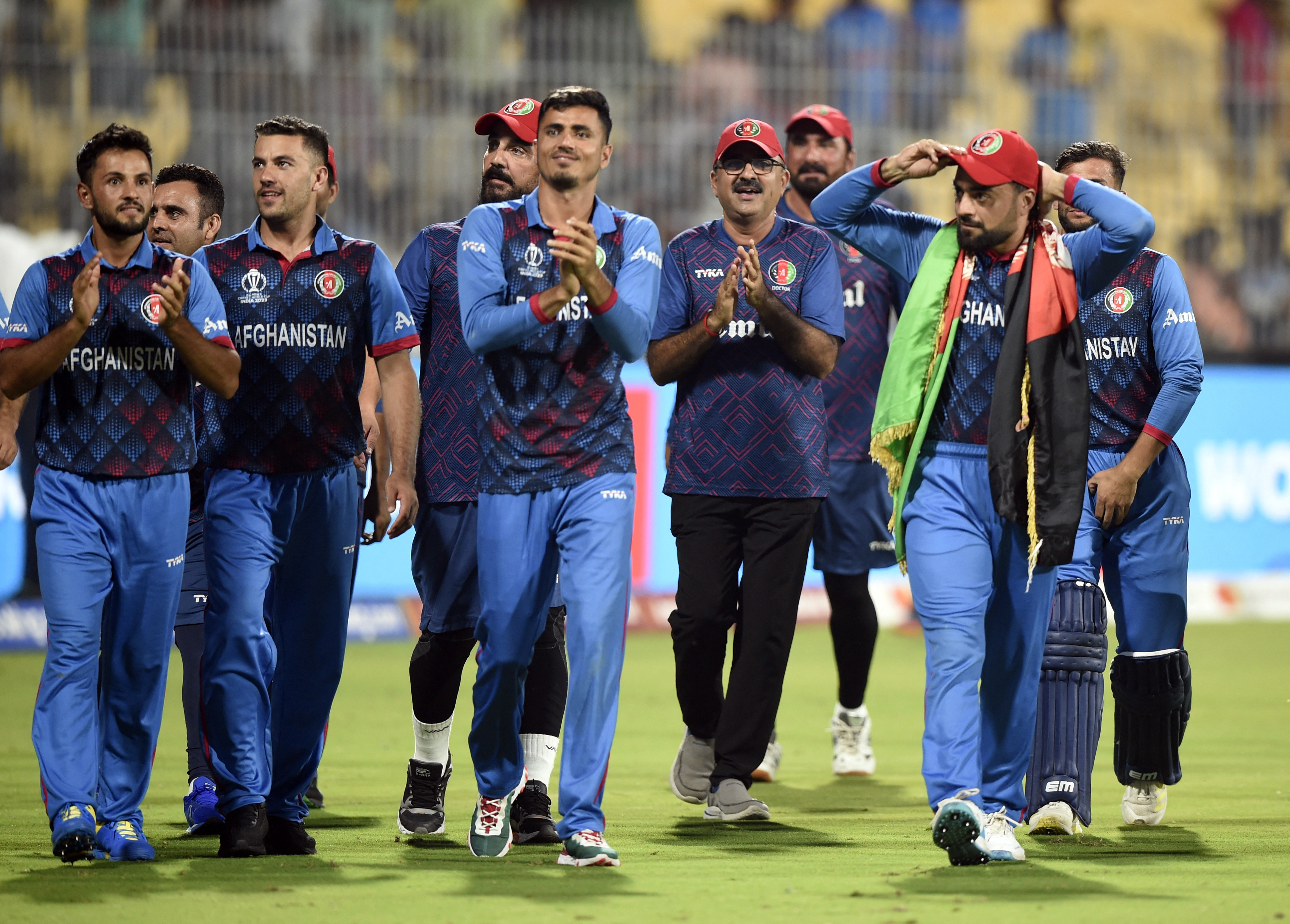Cricket - ICC Cricket World Cup 2023 - Pakistan v Afghanistan - MA Chidambaram Stadium, Chennai, India - October 23, 2023 Afghanistan players applaud fans after winning the match by 8 wickets REUTERS/Samuel Rajkumar