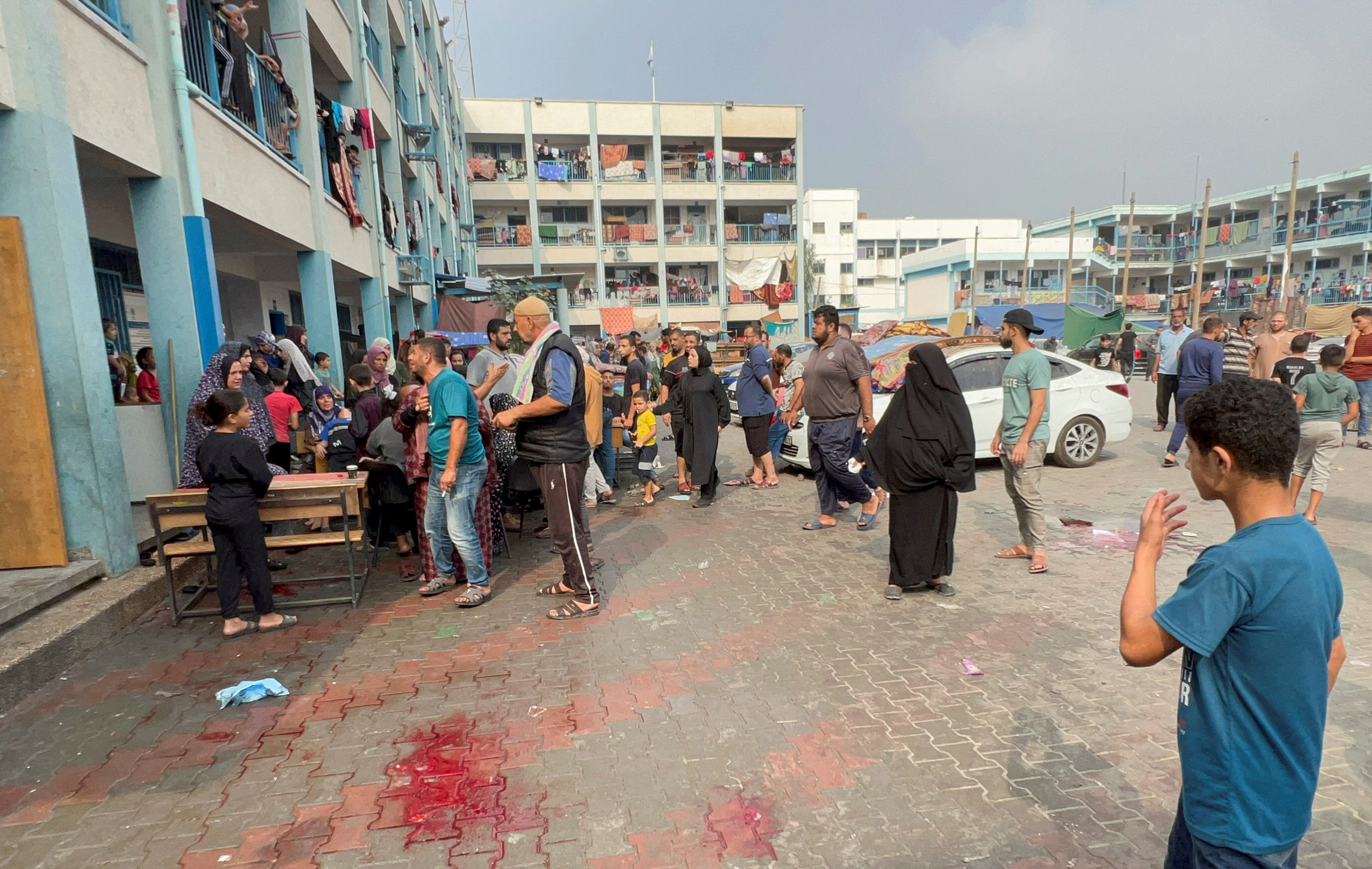 Palestinians react at the damages at a UN-run school sheltering displaced people, following an Israeli strike, in Jabalia on Thursday