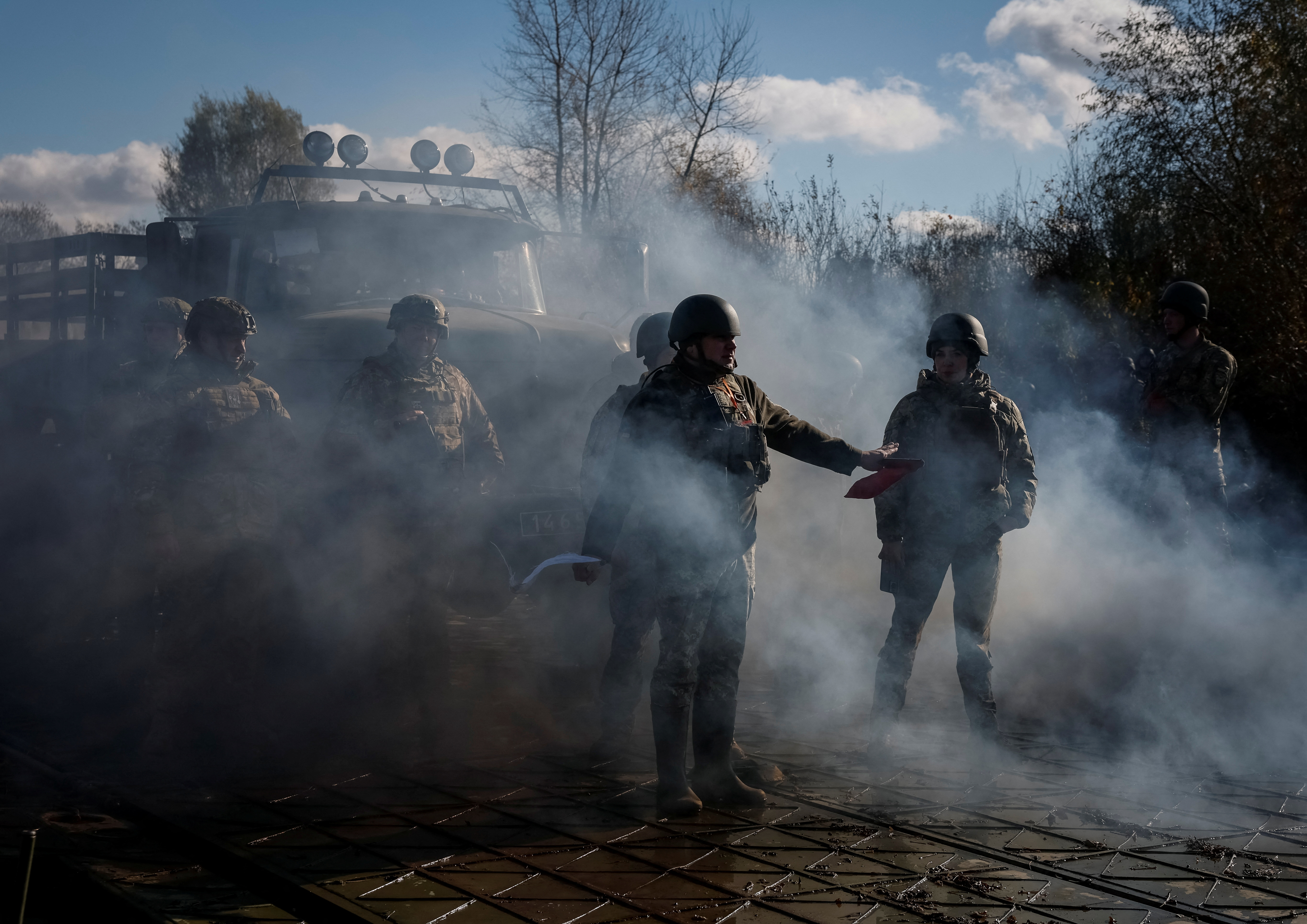 Ukrainian servicemen stand as they build pontoon bridges during an exercise in Chernihiv region, Ukraine, November 2
