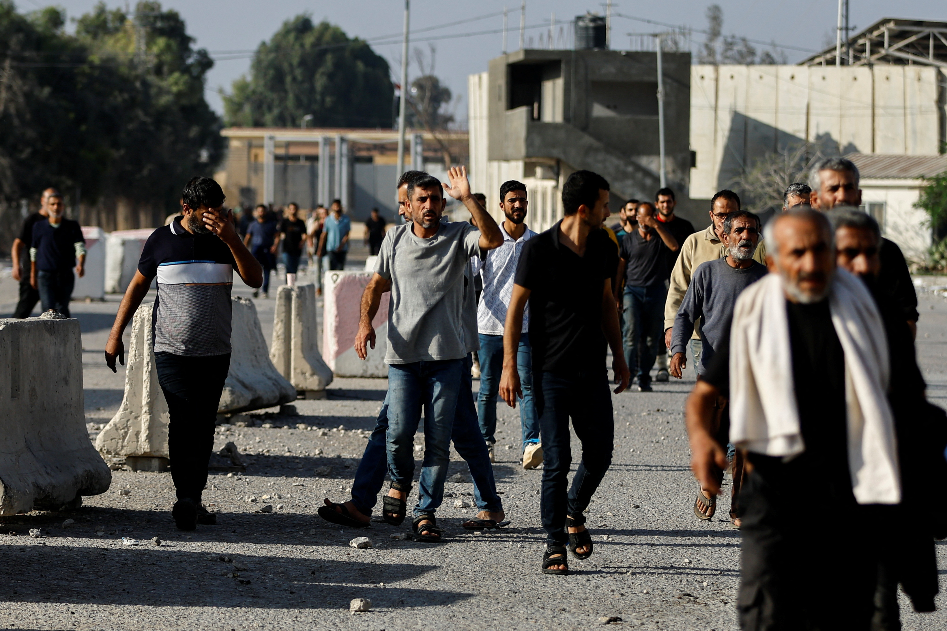 Palestinian labourers, who were in Israel during the Hamas October 7 attack, arrive at the Rafah border after being sent back by Israel to the strip, in the southern Gaza Strip.