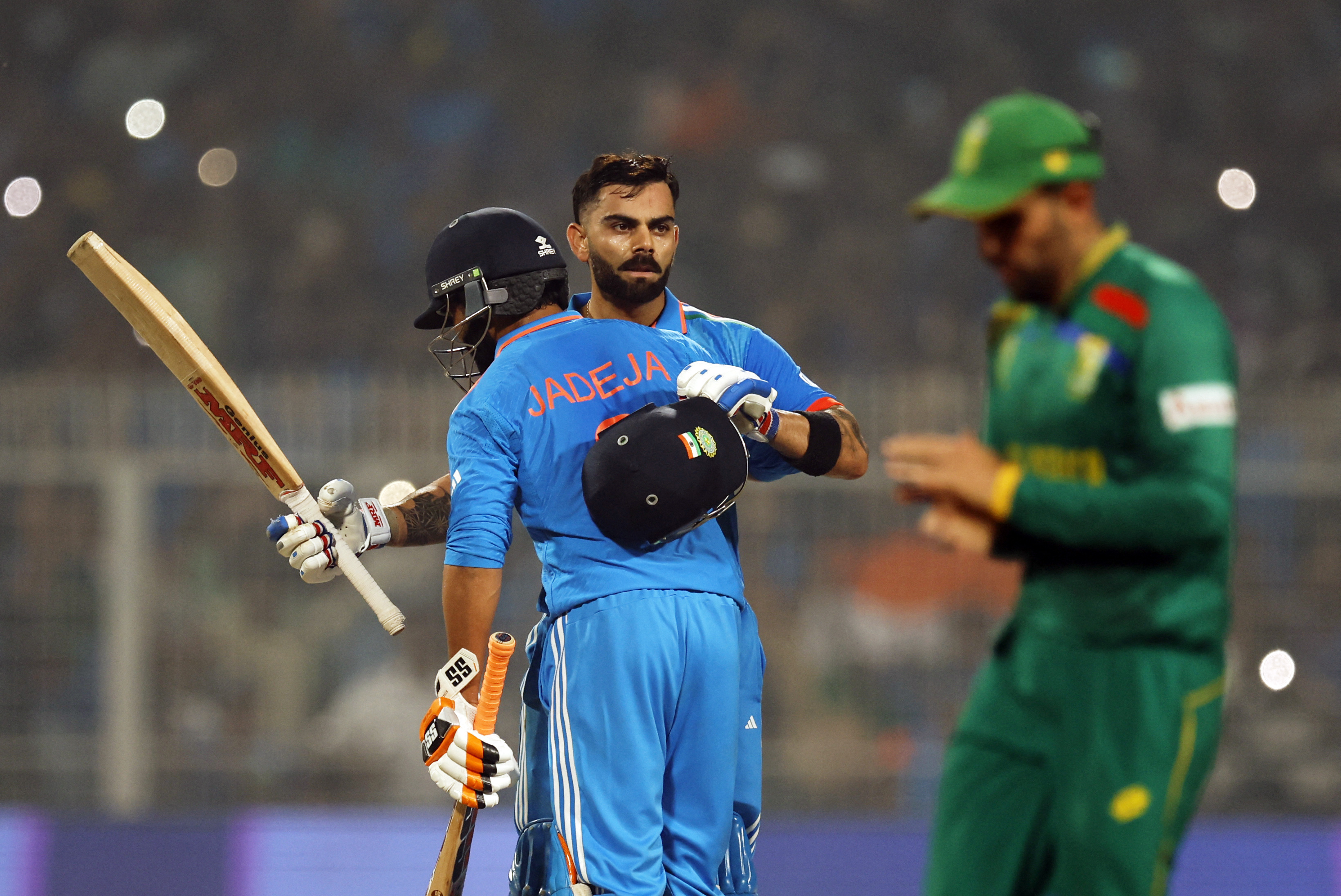 Cricket - ICC Cricket World Cup 2023 - India v South Africa - Eden Gardens, Kolkata, India - November 5, 2023 India's Virat Kohli celebrates with Ravindra Jadeja after reaching his 49th century, equalizing with Sachin Tendulkar's record of most number of ODI centuries [File: Adnan Abidi/REUTERS]
