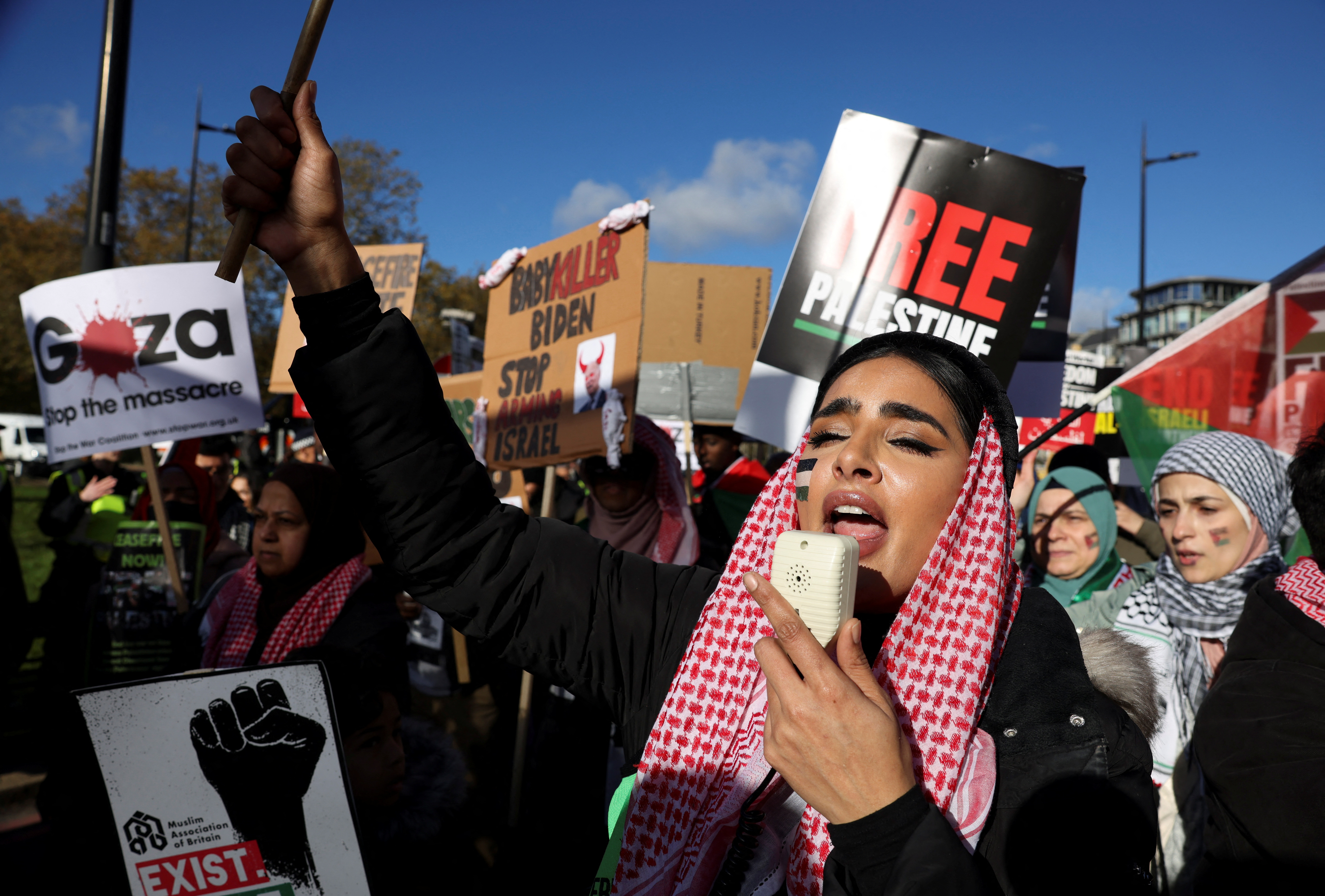 A woman speaks as people protest in solidarity with Palestinians in Gaza, amid the ongoing conflict between Israel and the Palestinian Islamist group Hamas, in London, Britain, November 11, 2023. REUTERS/Hollie Adams