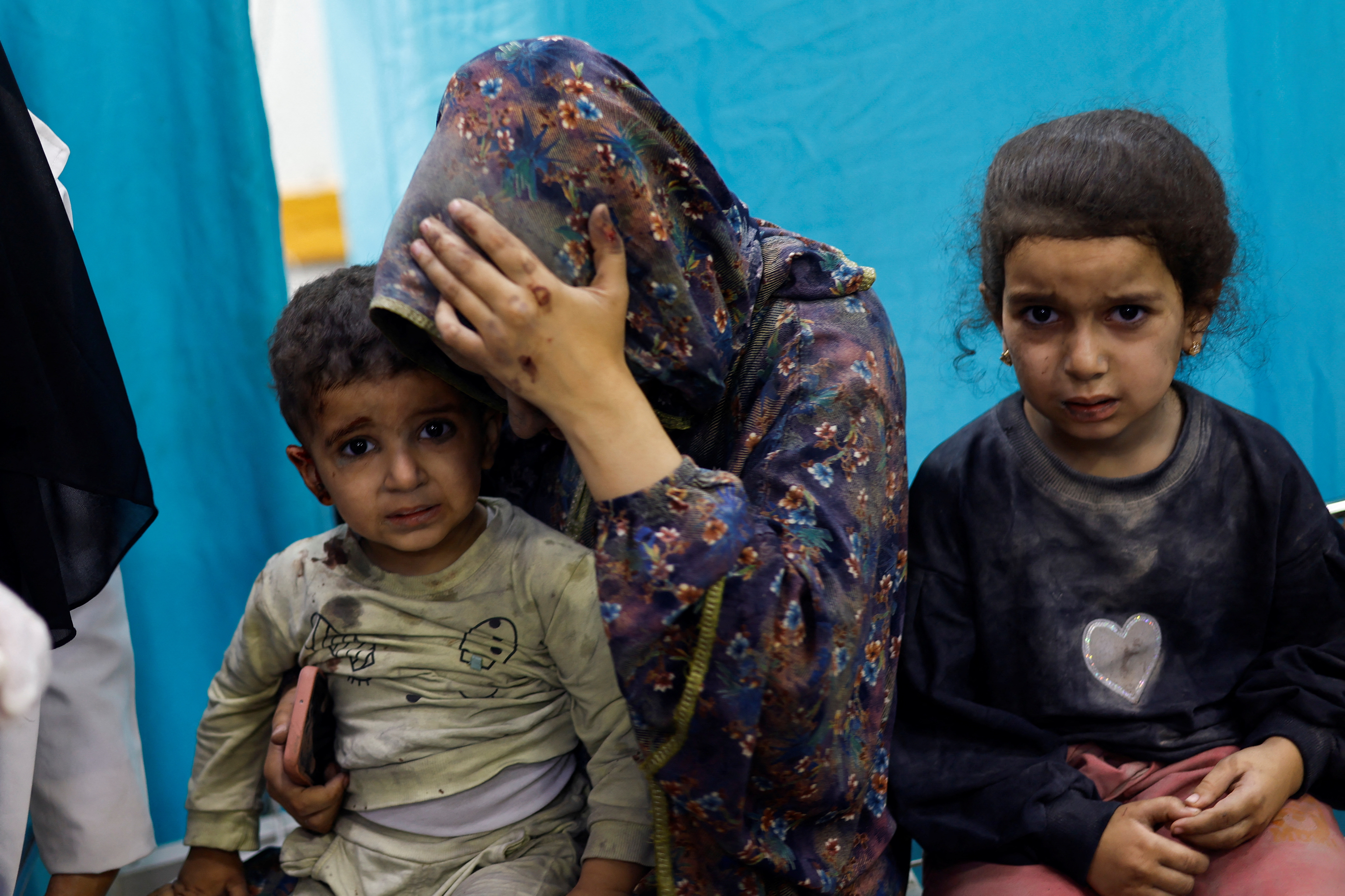 Palestinian children wounded in Israeli strikes wait to receive treatment at Nasser hospital in Khan Younis in the southern Gaza Strip November 12