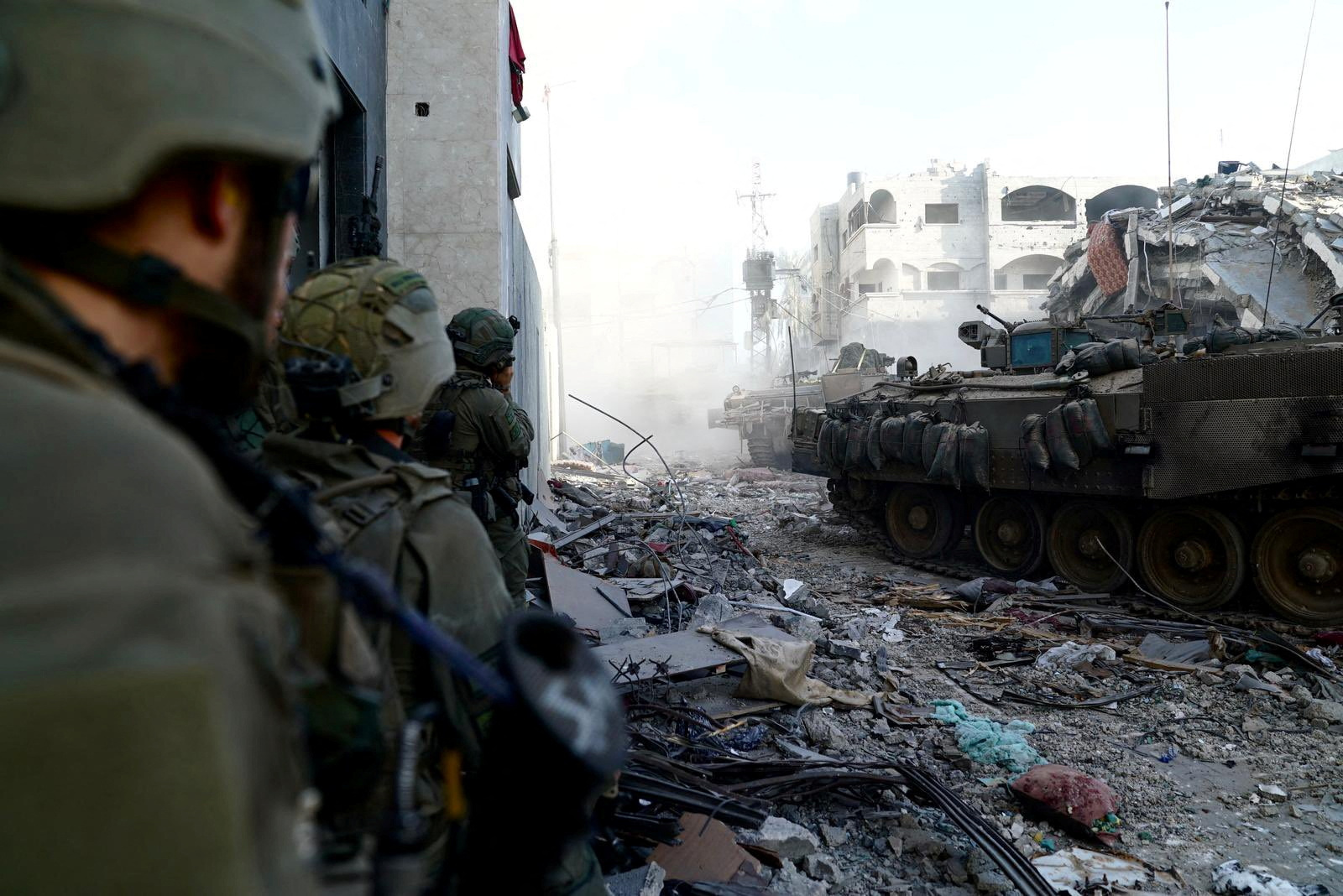 Israeli soldiers take position, amid the ongoing ground operation of the Israeli army against Hamas, in the Gaza Strip as seen in a handout picture released by the Israel Defense Forces.